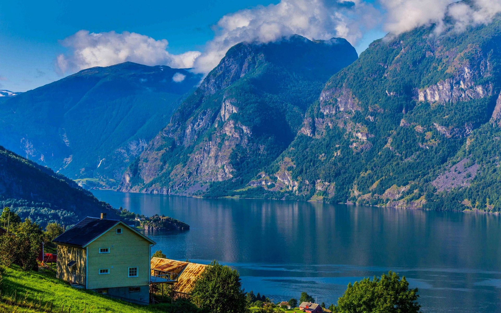 Yellow house by a fjord with mountains HD Wallpaper