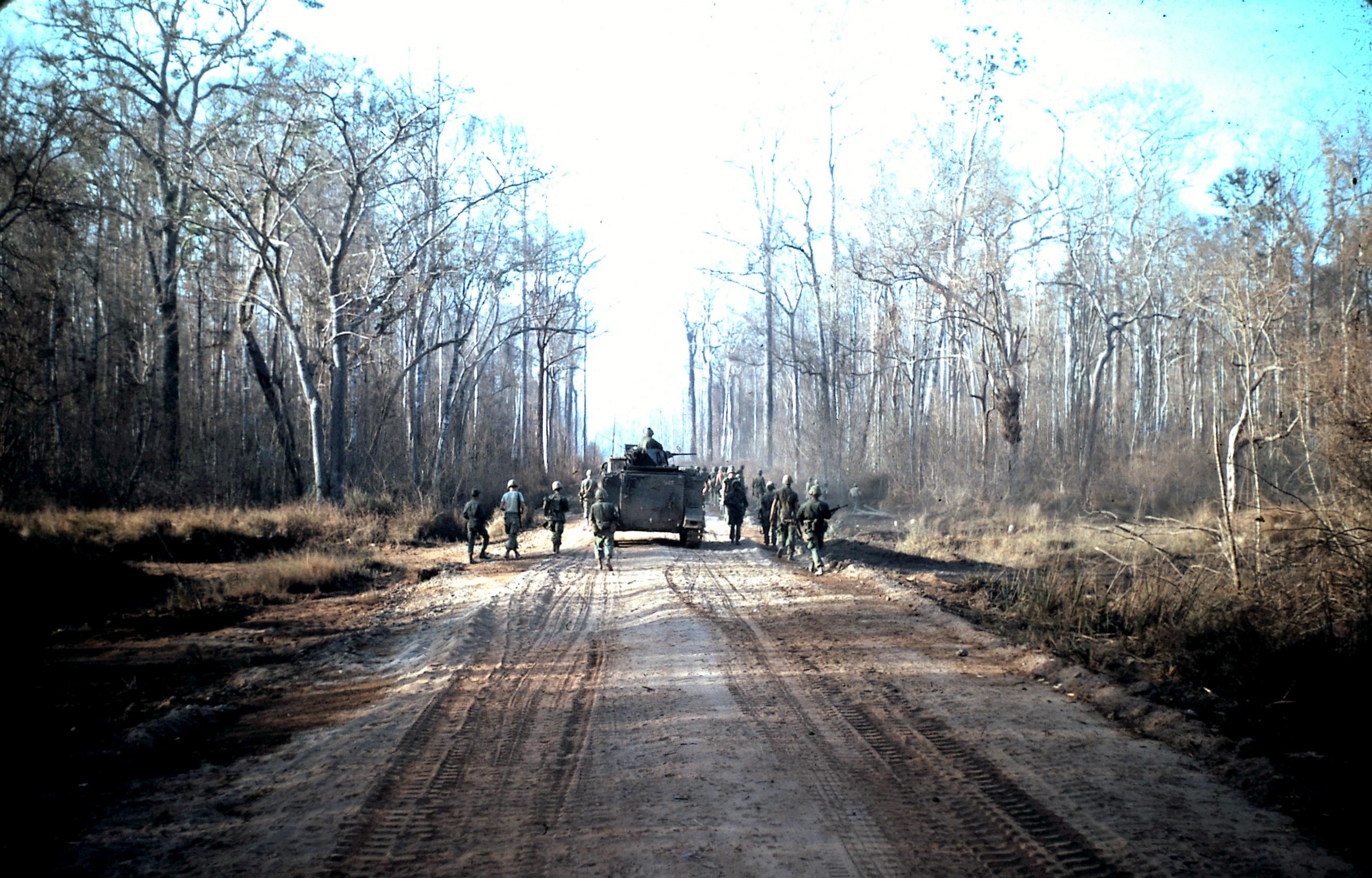 Vietnam War Troops Moving Through Forest Path HD Wallpaper