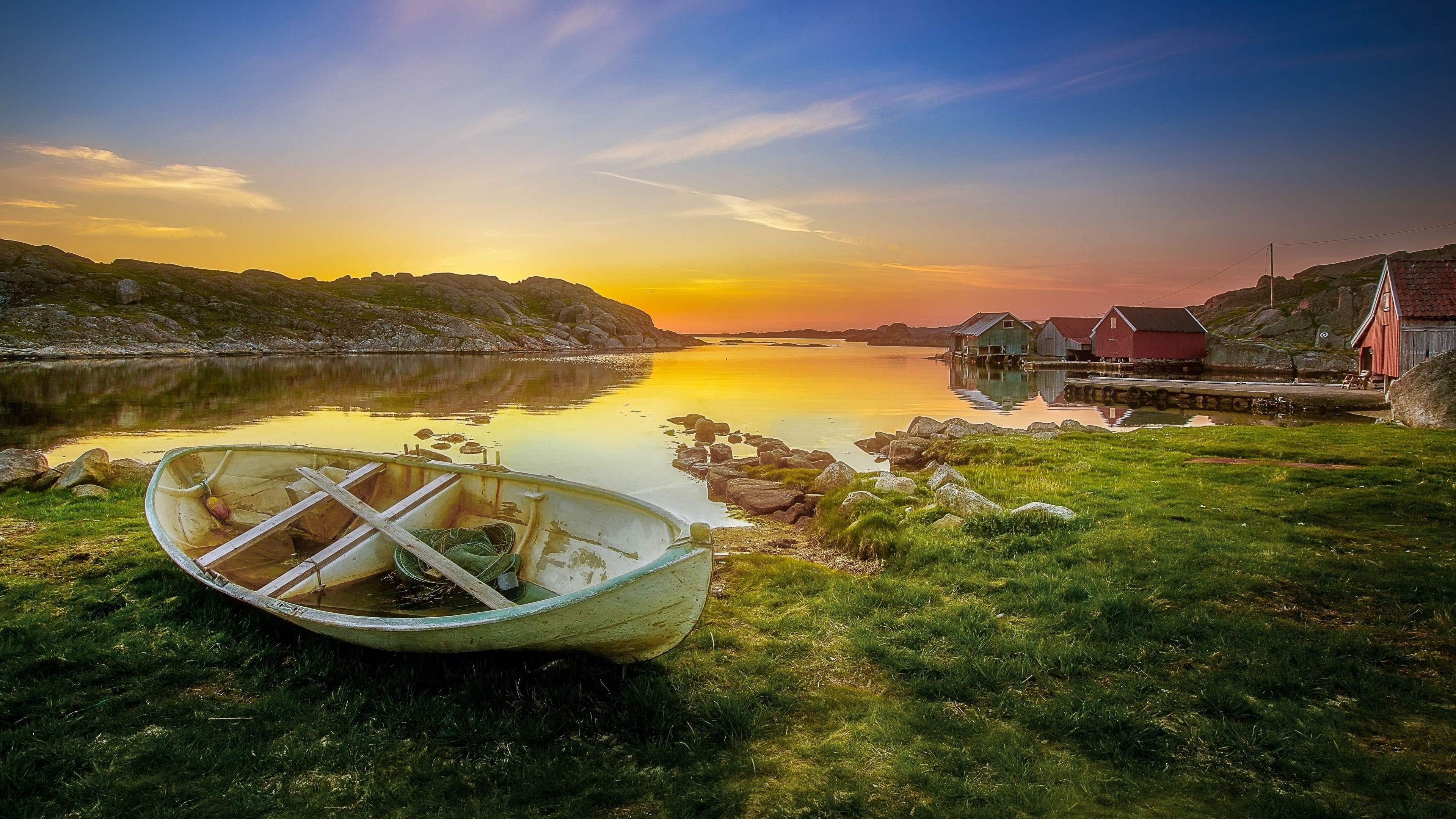 4K image of a boat by the water at sunset HD Wallpaper