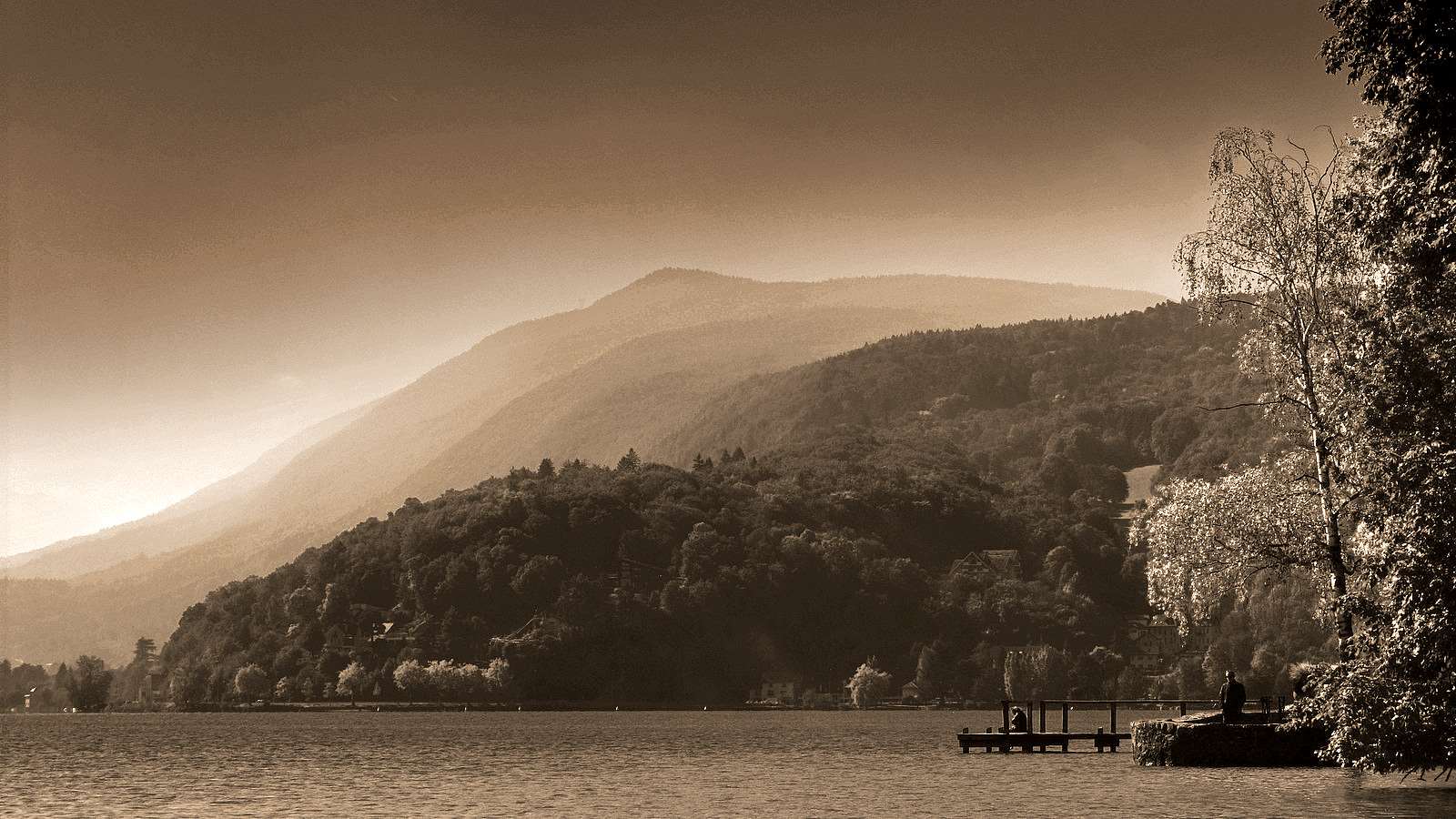Sepia landscape of misty mountains over a lake with a dock HD Wallpaper