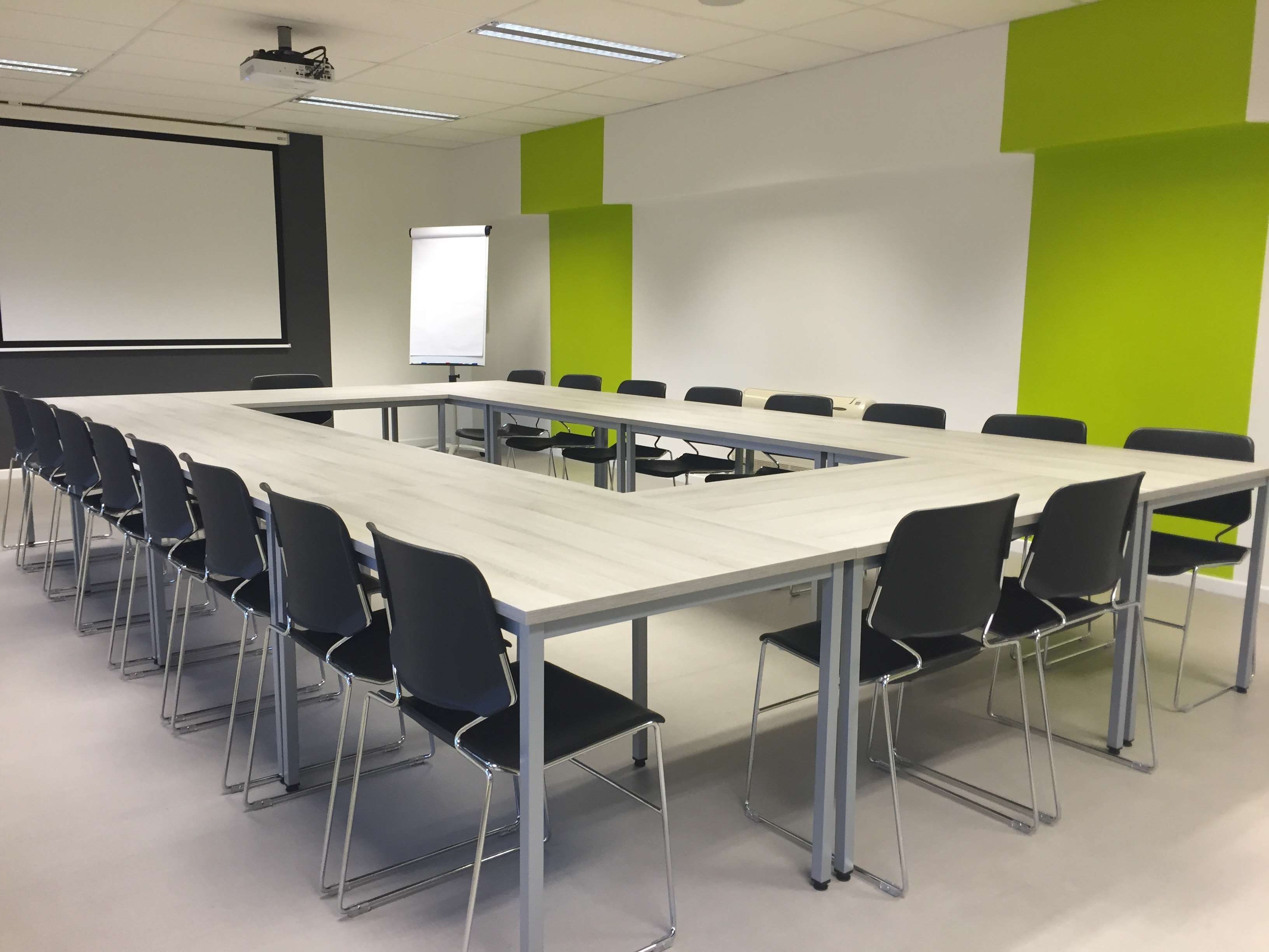 Conference room with U-shaped table and chairs HD Wallpaper