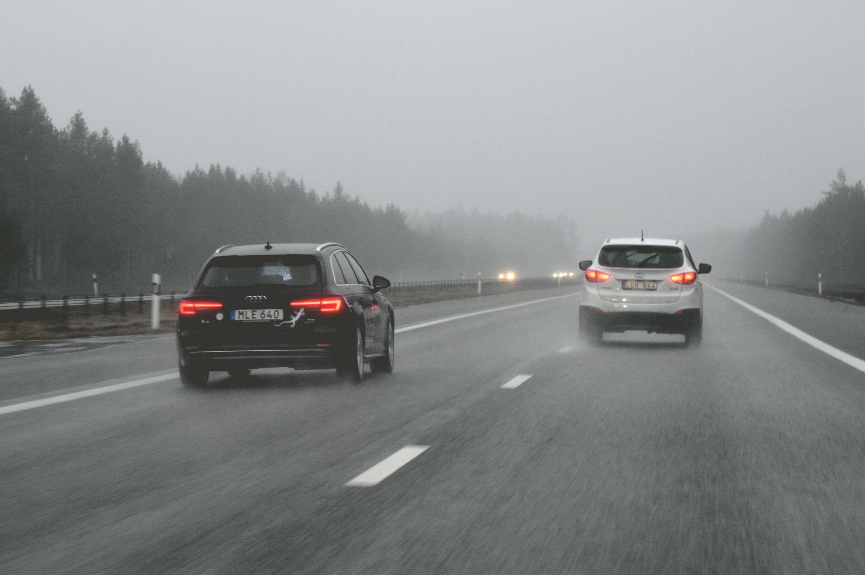 Cars driving on a foggy highway in Sweden HD Wallpaper
