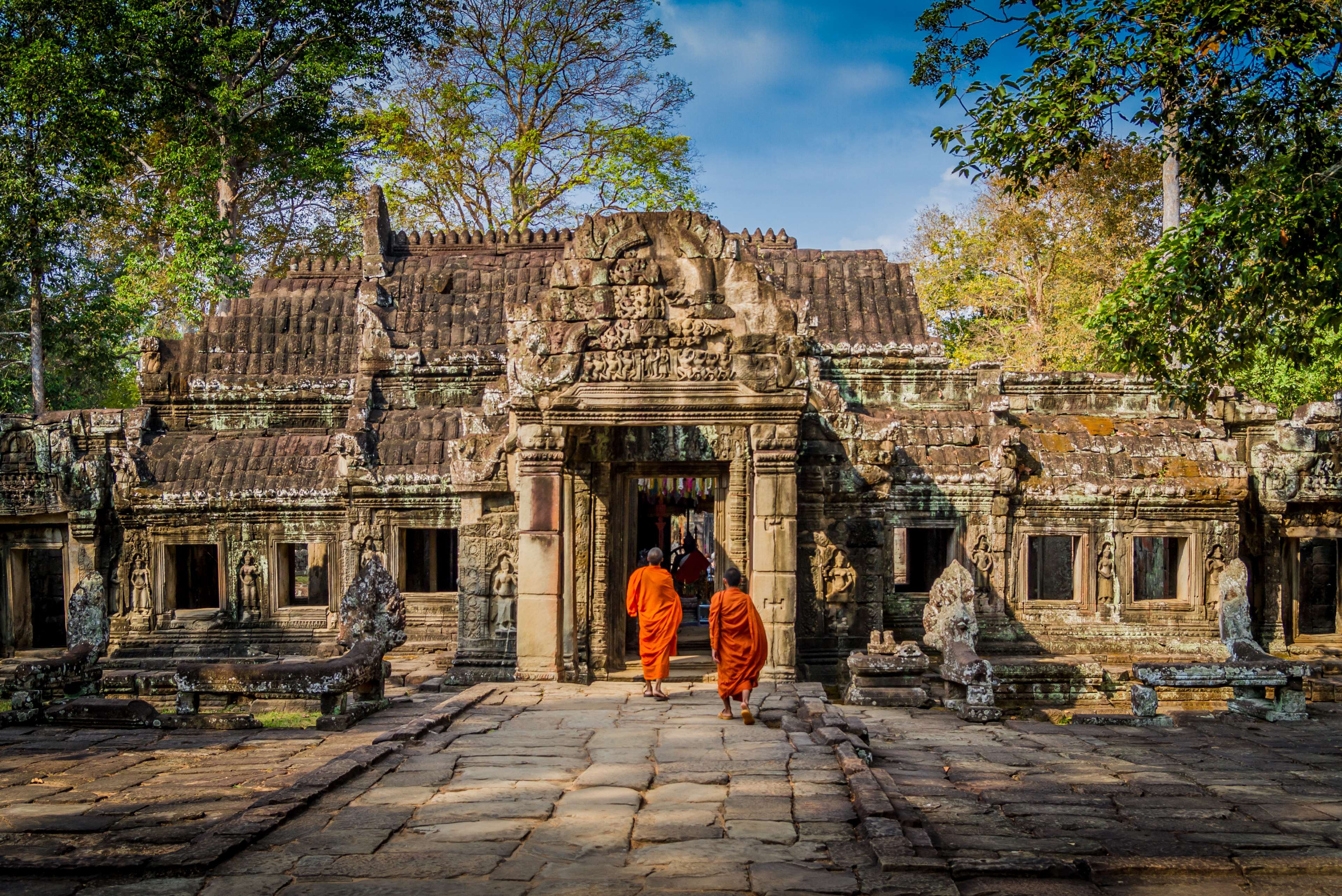 Two monks walking towards ancient temple in Angkor Wat, Cambodia 4K HD Wallpaper