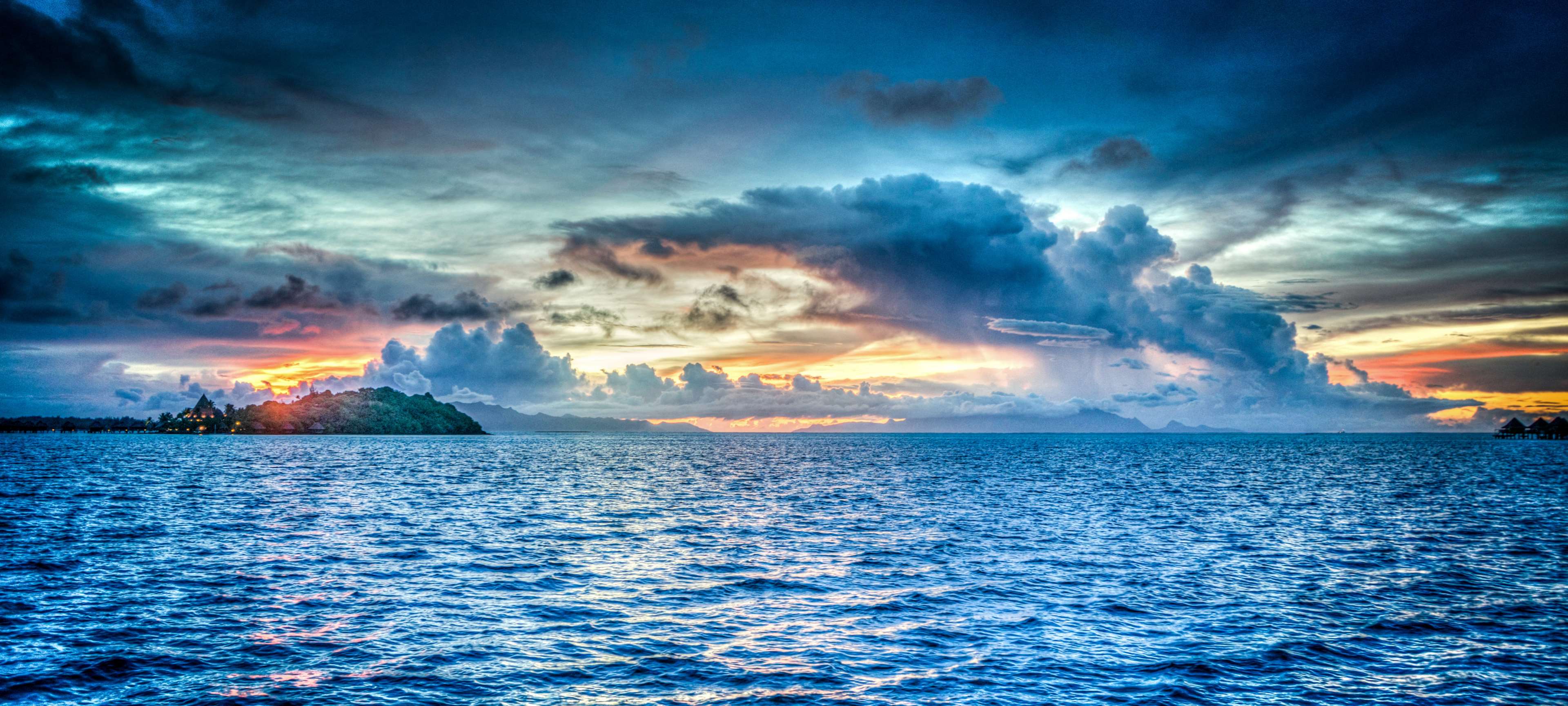 Ocean and Island at Sunset with Dramatic Clouds 4K HD Wallpaper
