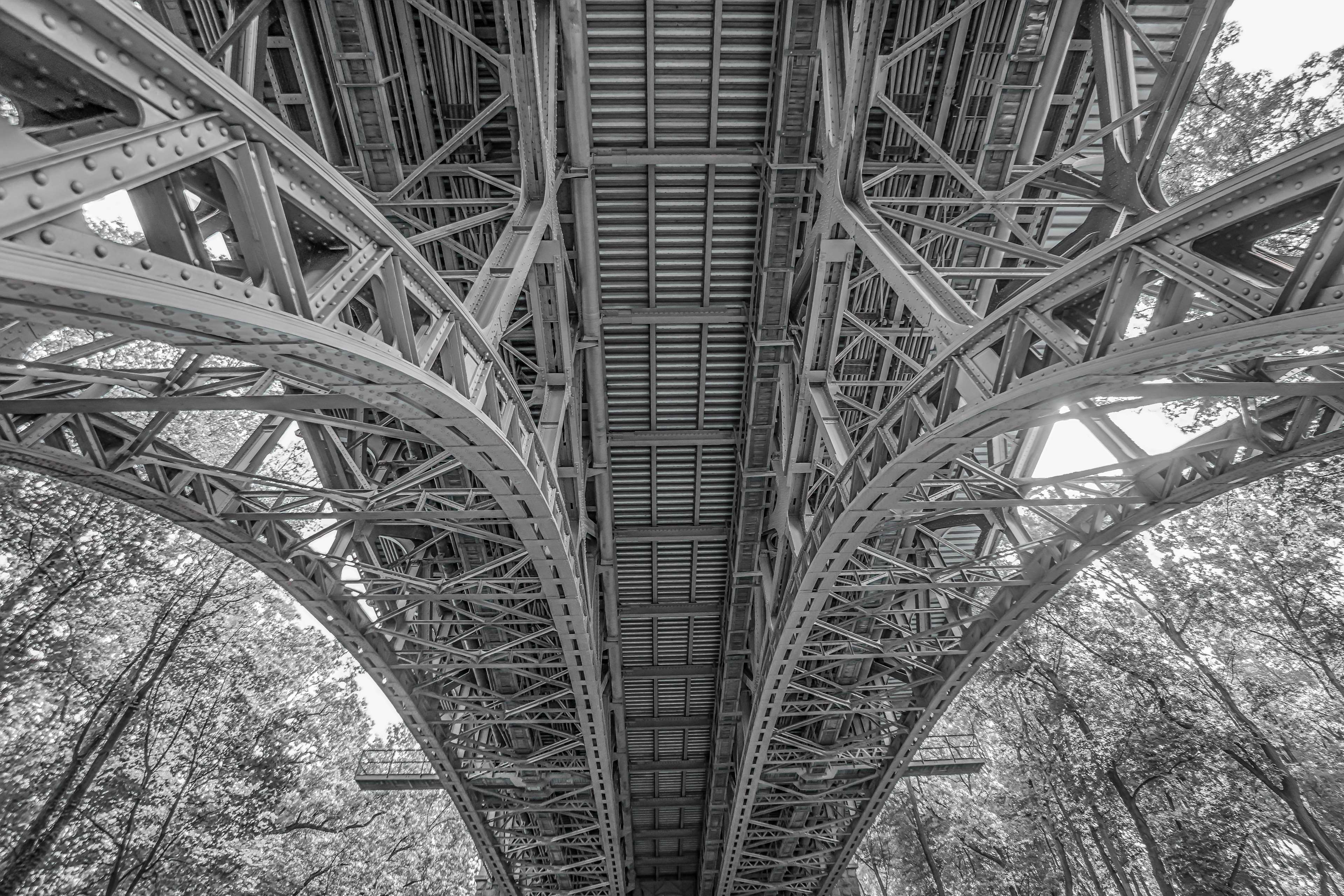 Underside of a steel bridge in black and white HD Wallpaper