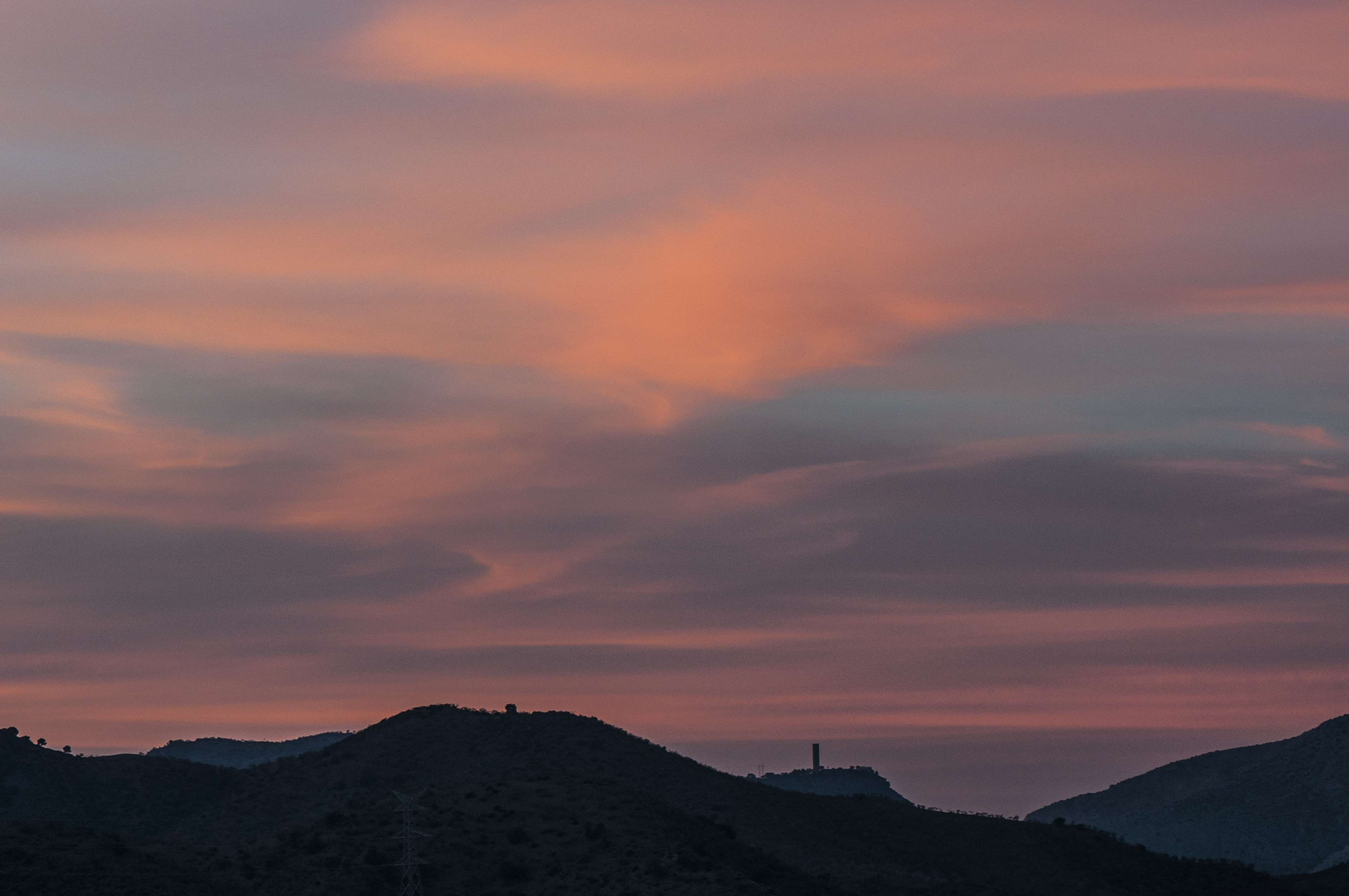 Sunset sky over silhouetted hills HD Wallpaper