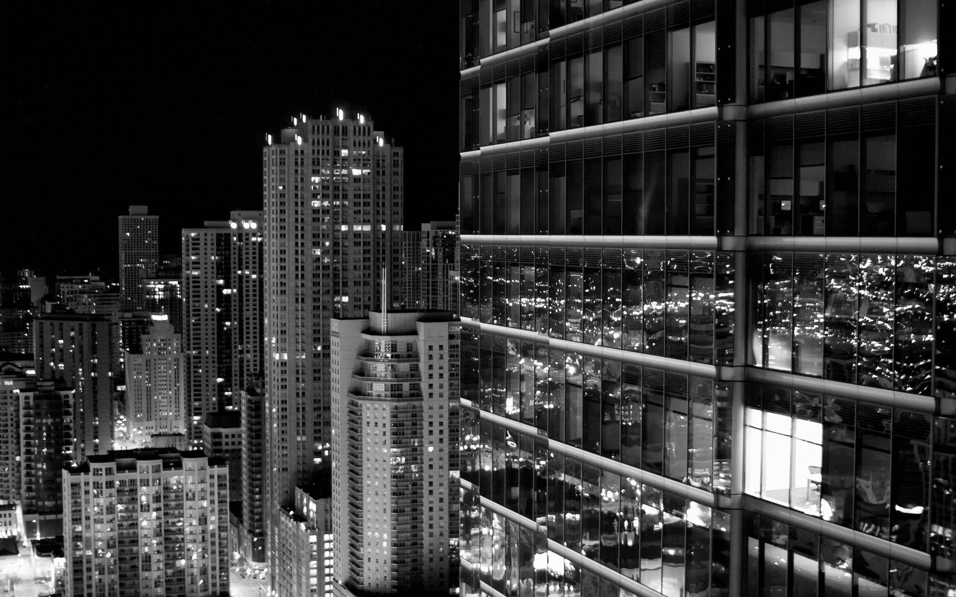 Black and white cityscape at night with skyscrapers HD Wallpaper