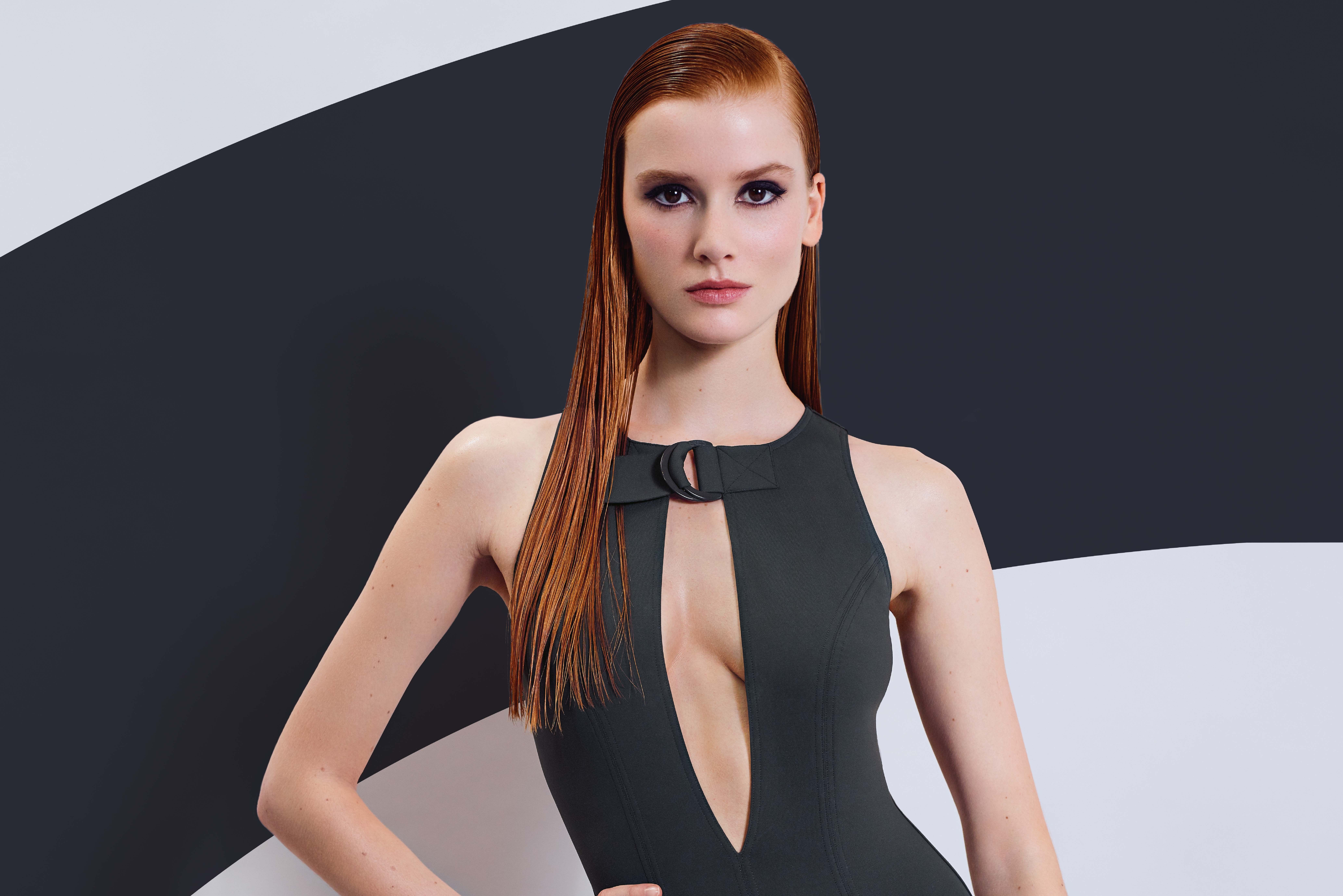 Elegant Woman in Sleek Black Dress with Red Hair 4K HD Wallpaper