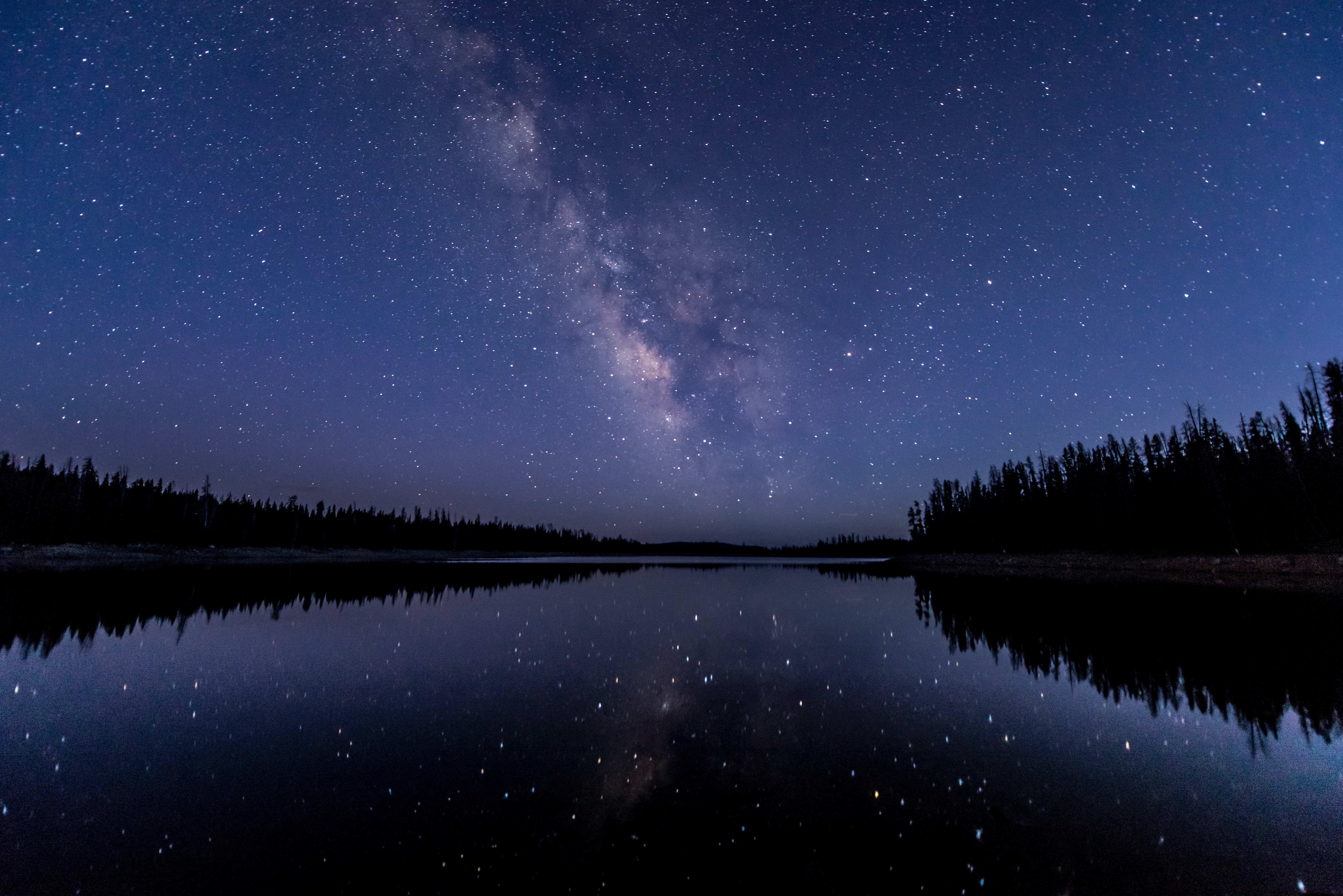 Milky Way over a reflective lake at night HD Wallpaper