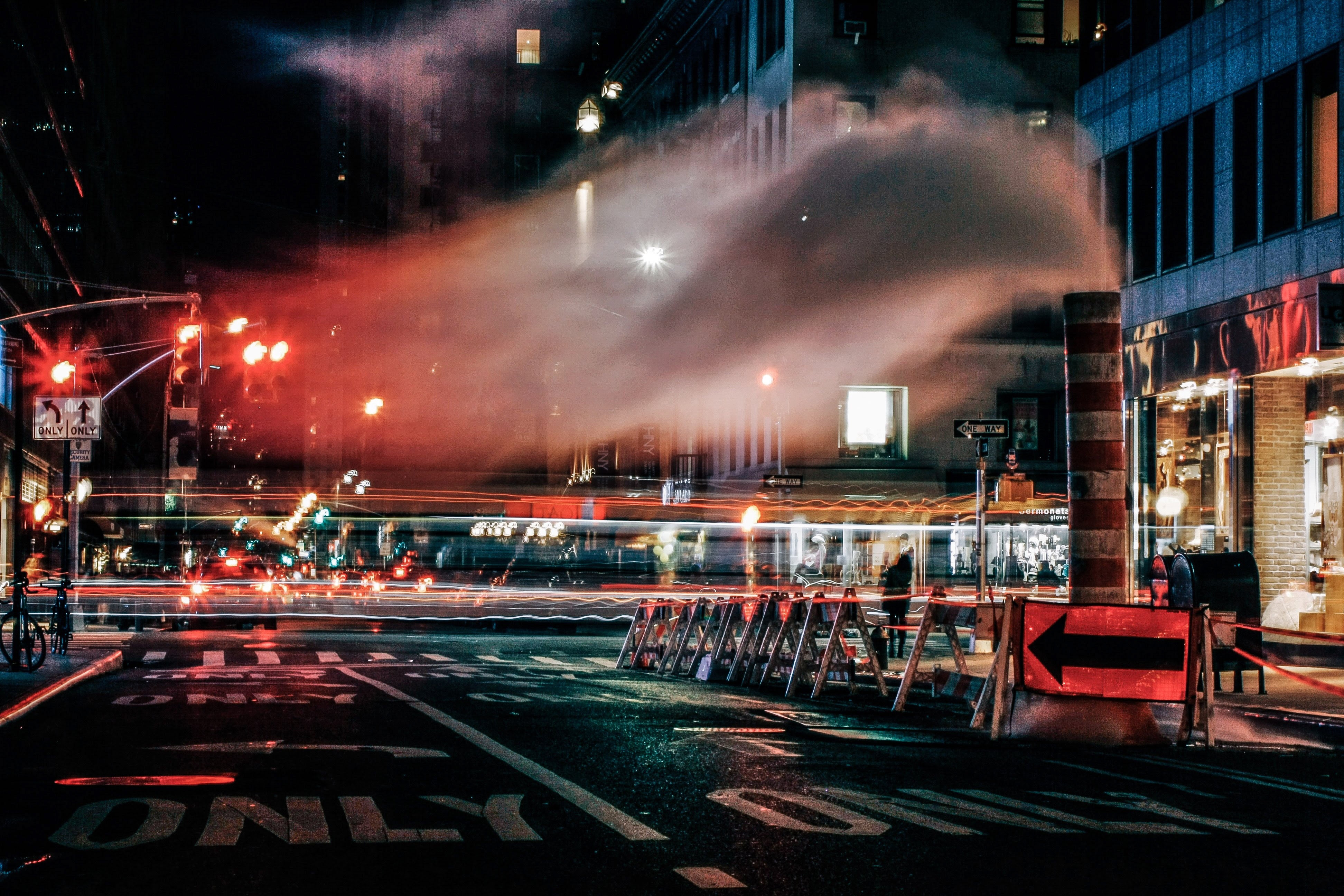 City street at night with steam and traffic lights HD Wallpaper