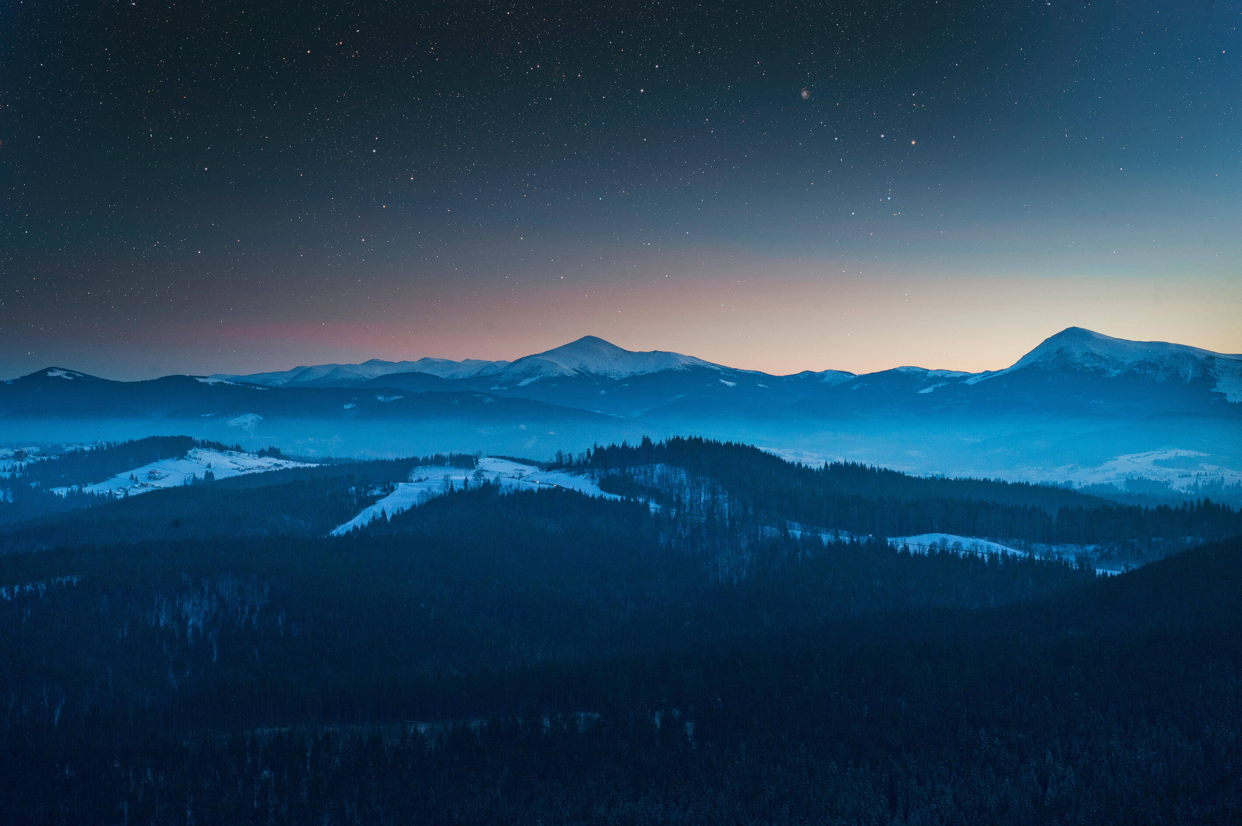 Mountains under starry sky with fog HD Wallpaper