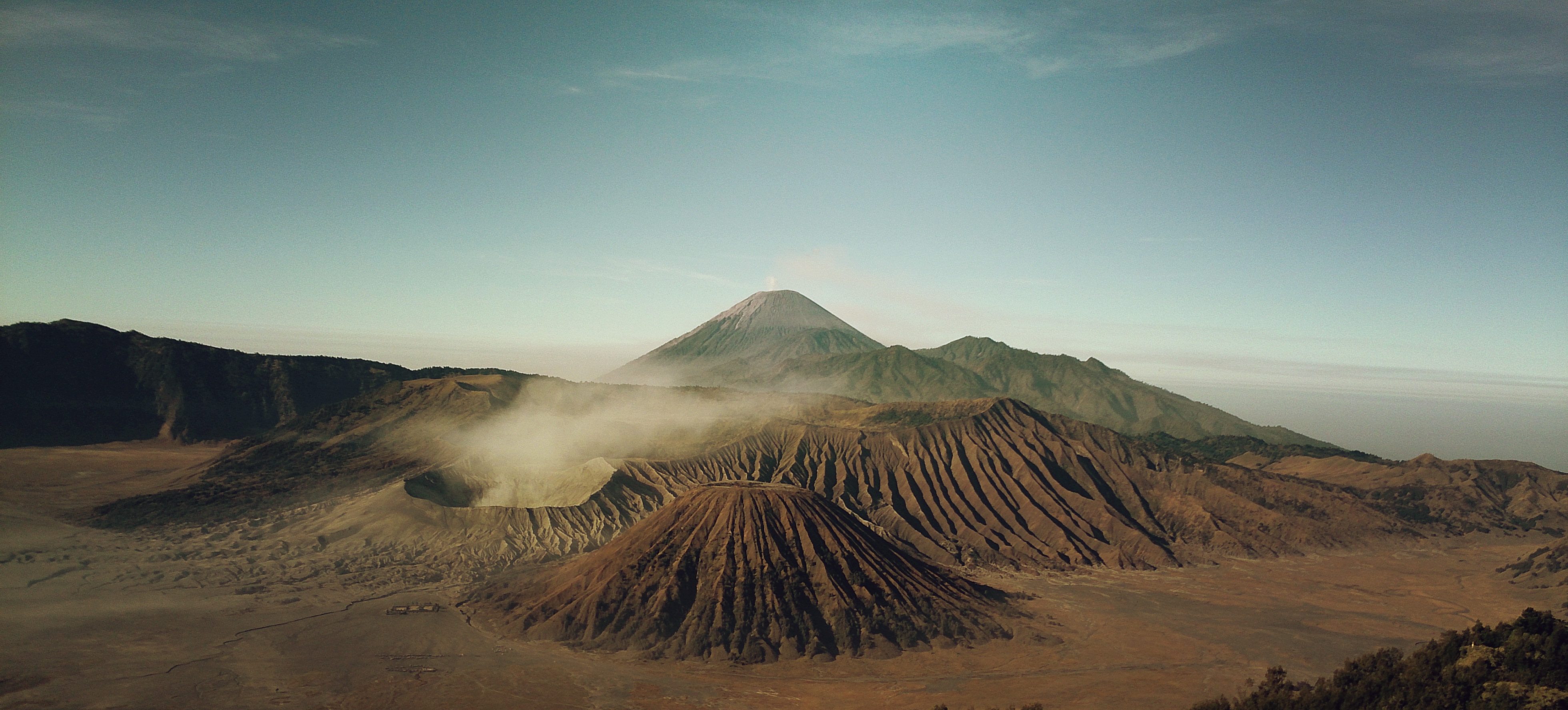Volcano landscape with smoke and mountains HD Wallpaper