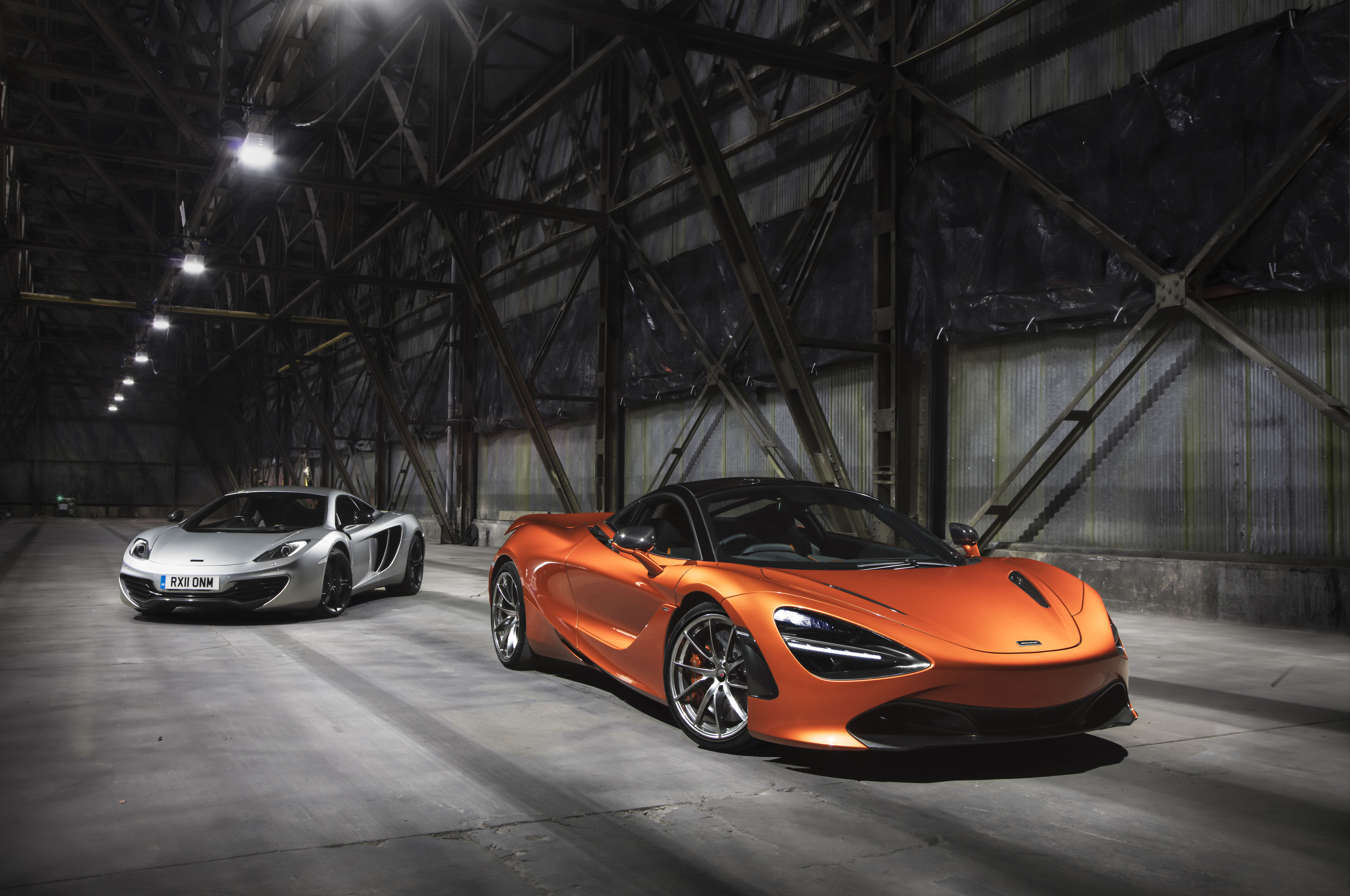 Two McLaren sports cars in a warehouse HD Wallpaper
