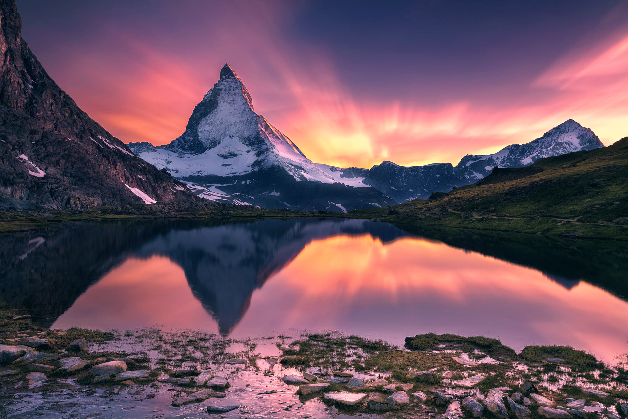 Matterhorn mountain reflected in a lake at sunset HD Wallpaper