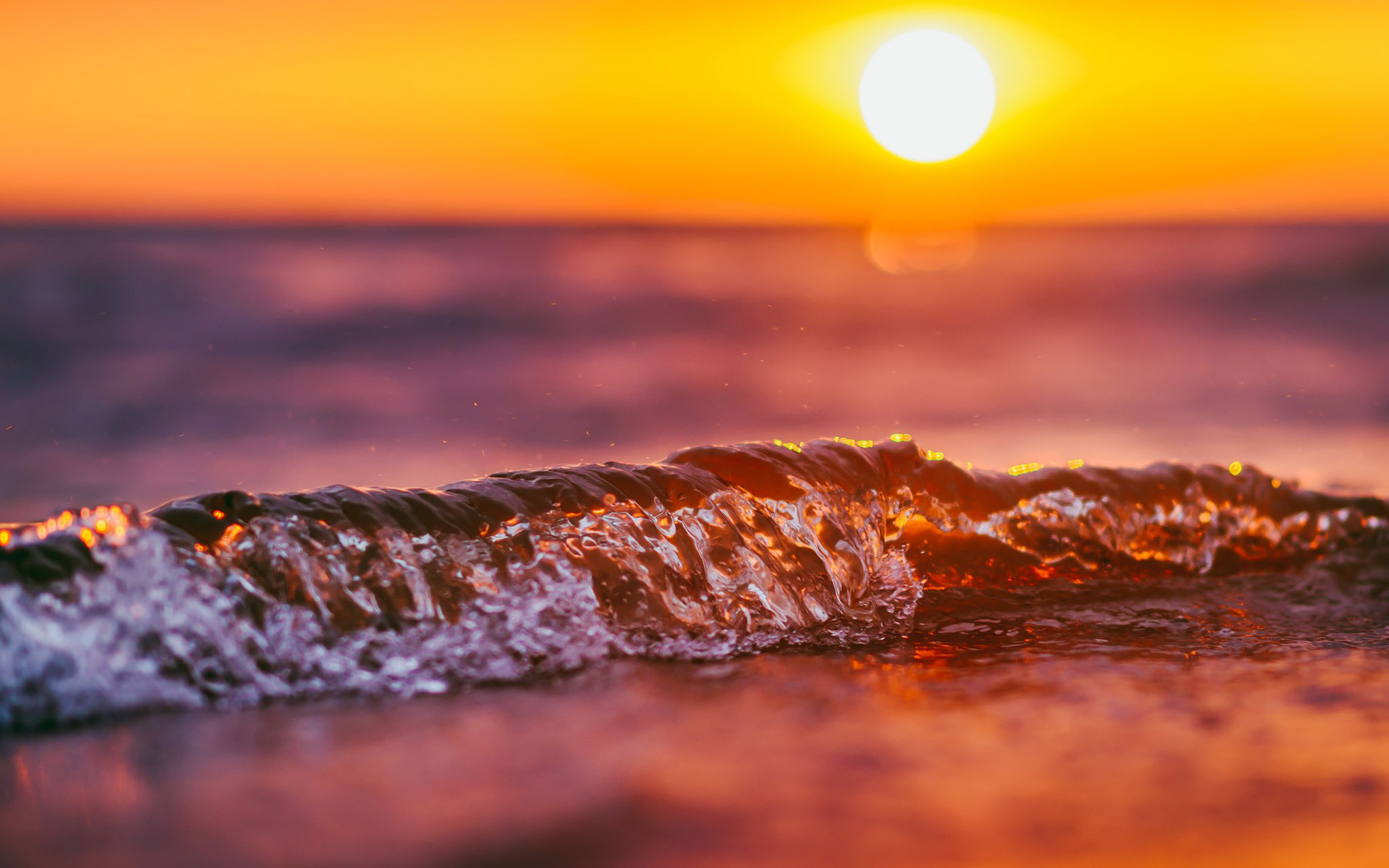 Sunset over the ocean with waves HD Wallpaper