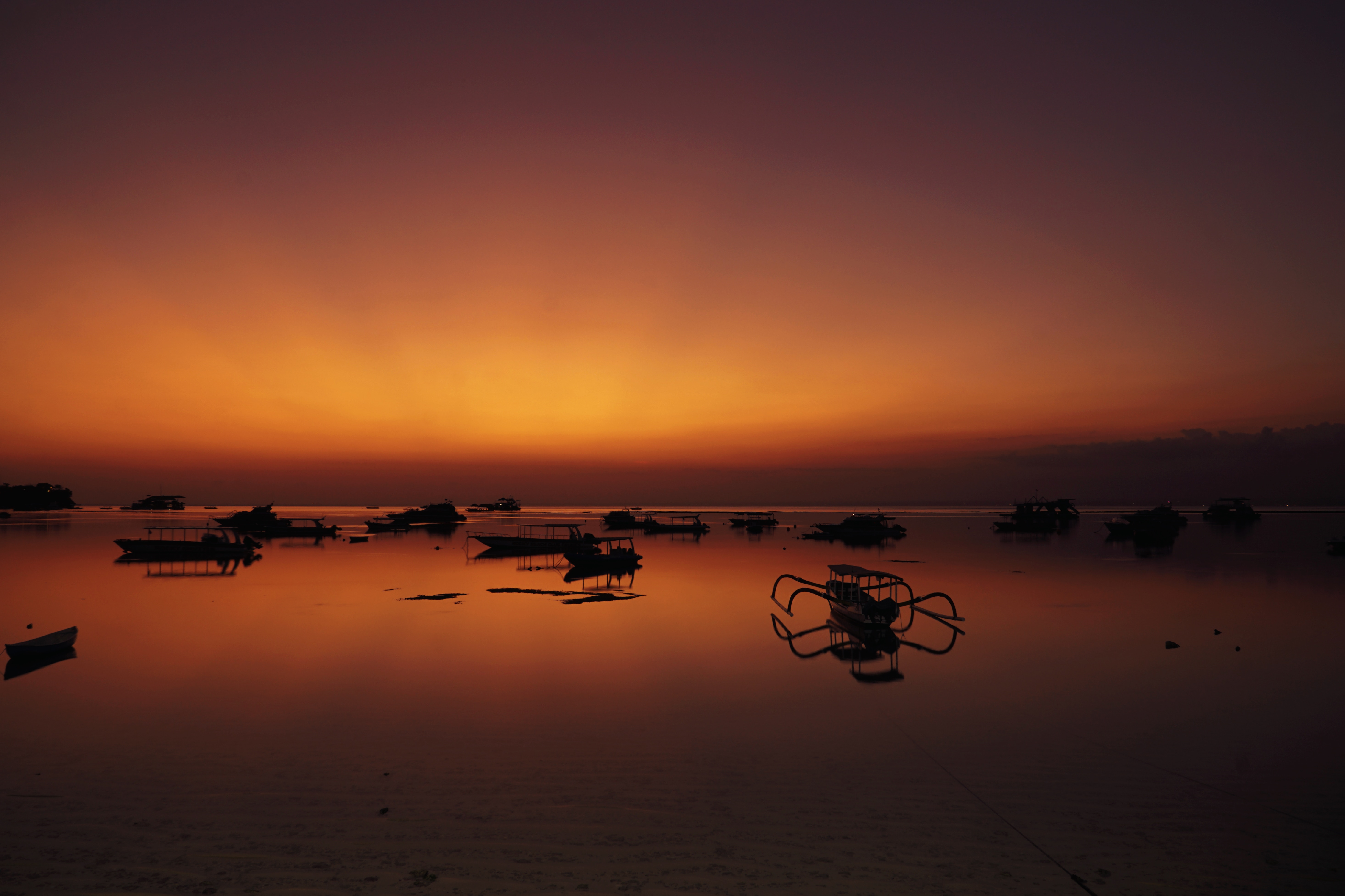 Boats on the water at sunset in Bali HD Wallpaper