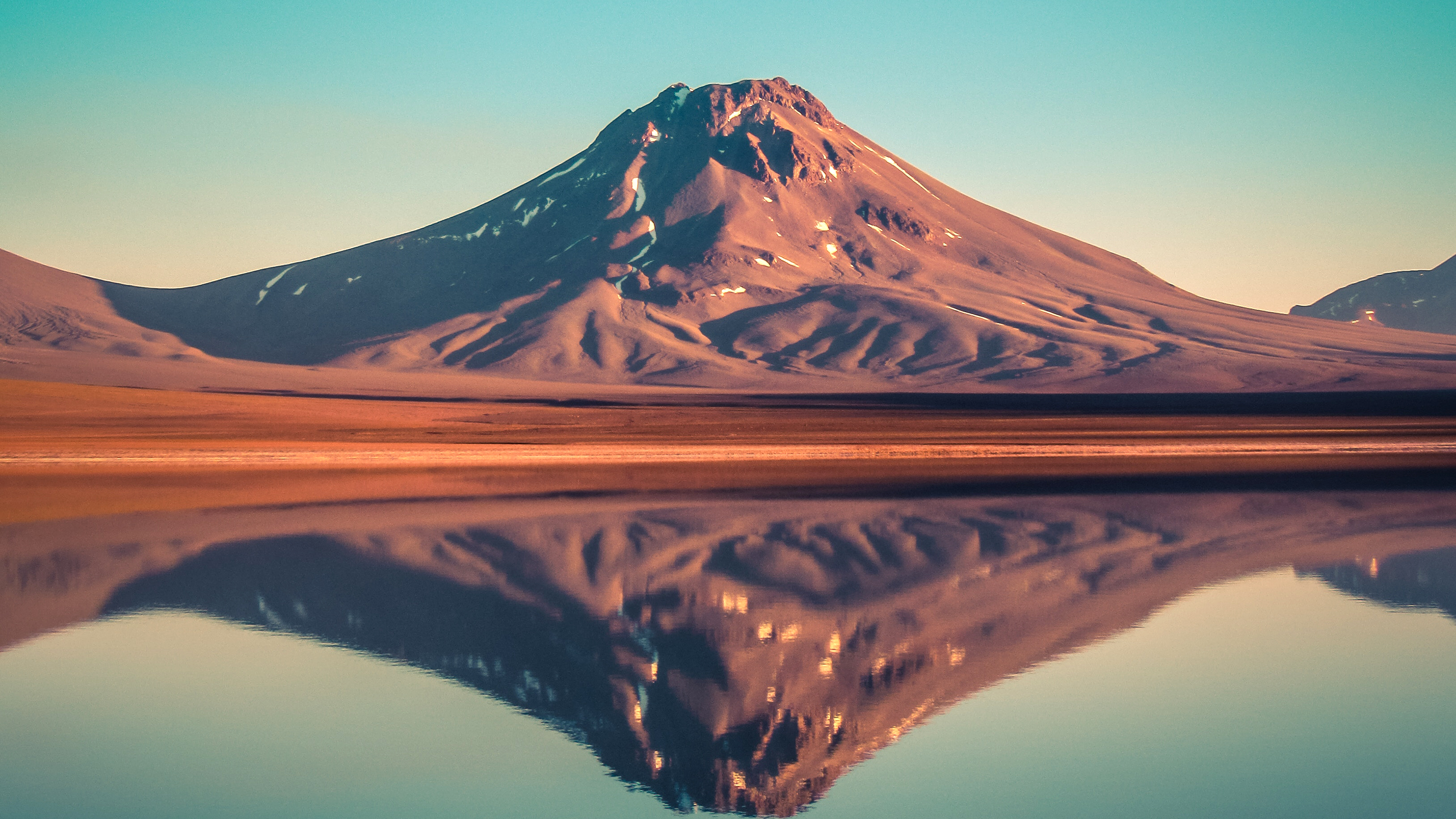 Mountain reflected in a calm lake at sunset HD Wallpaper