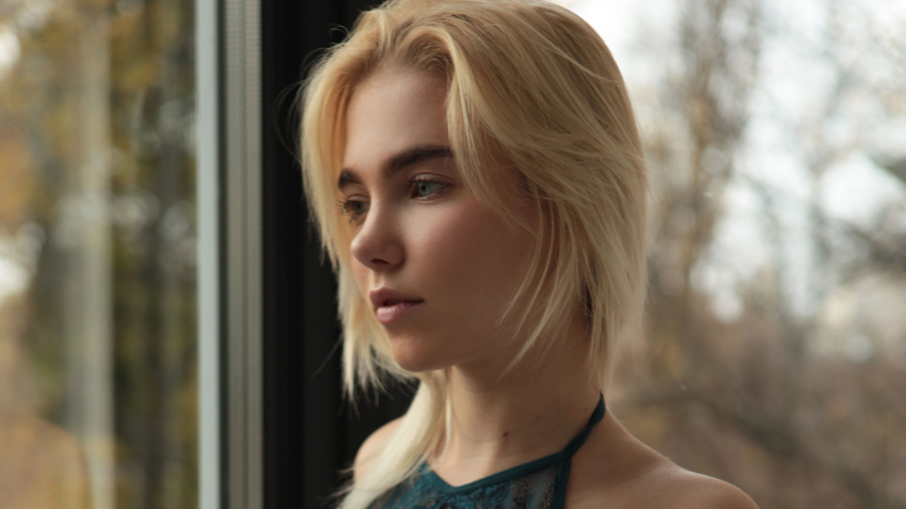 Blonde girl looking out a window HD Wallpaper