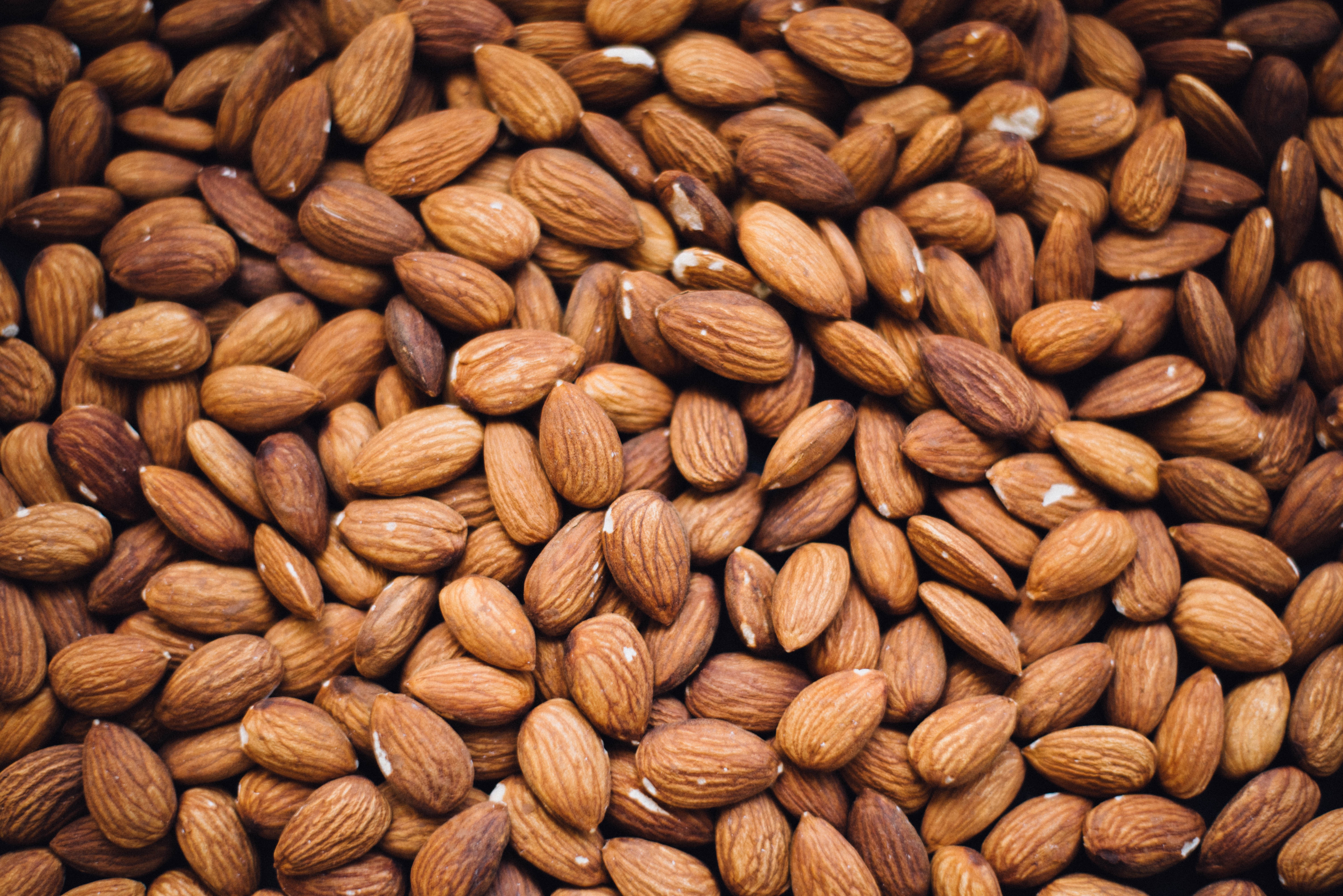 A pile of healthy almonds HD Wallpaper