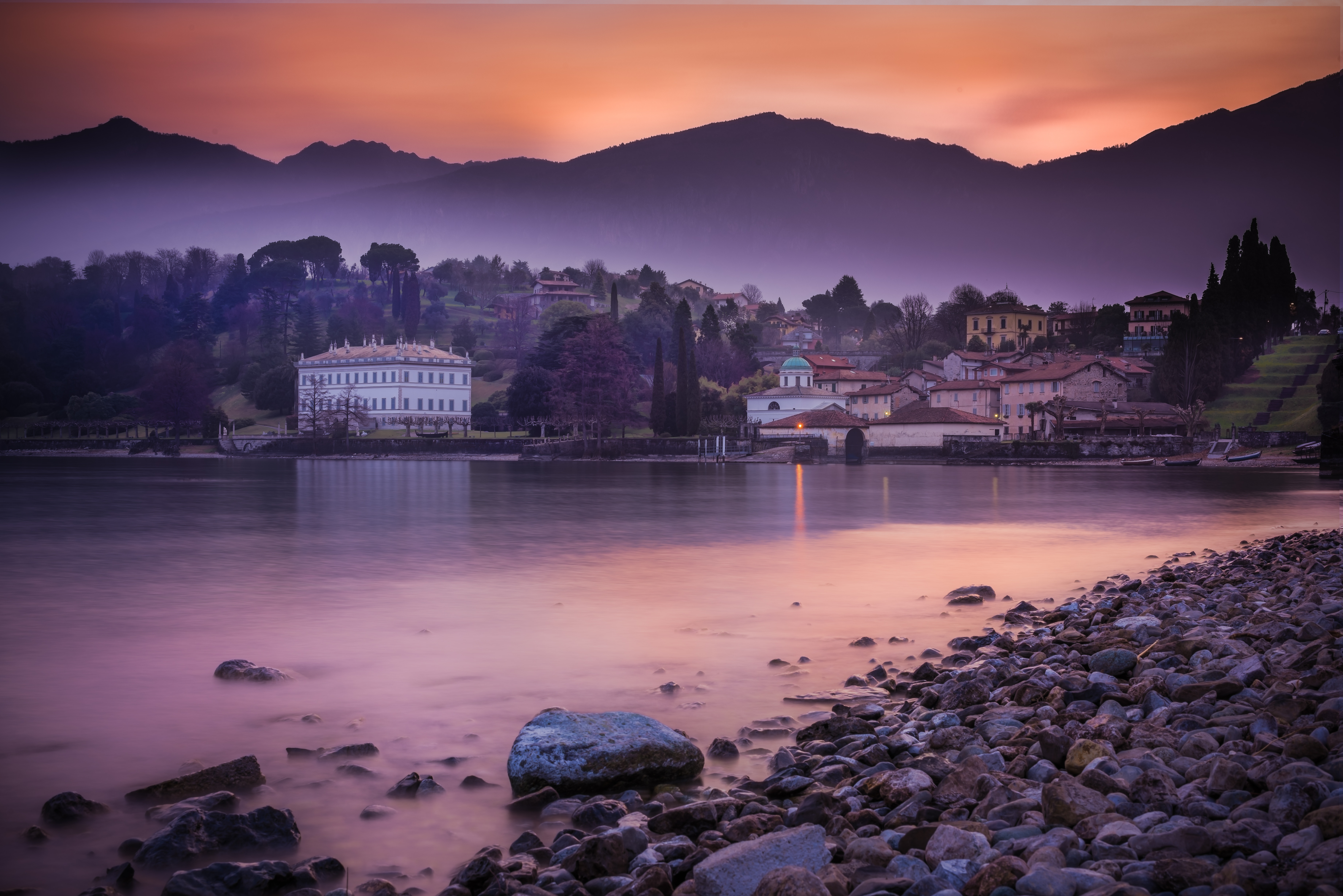 Lake Como at sunset with mountains and buildings HD Wallpaper