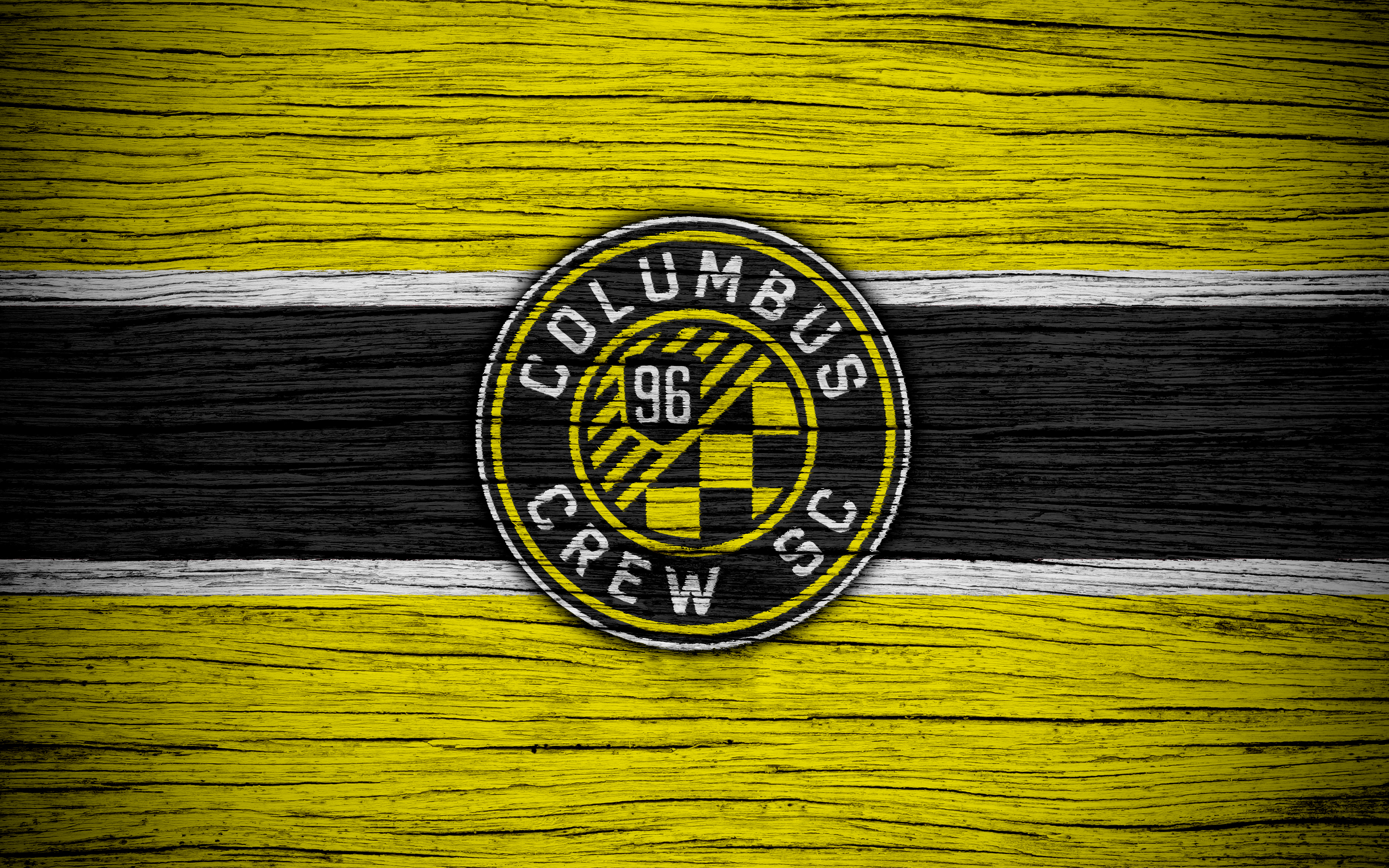 Columbus Crew SC logo on yellow and black wood grain HD Wallpaper