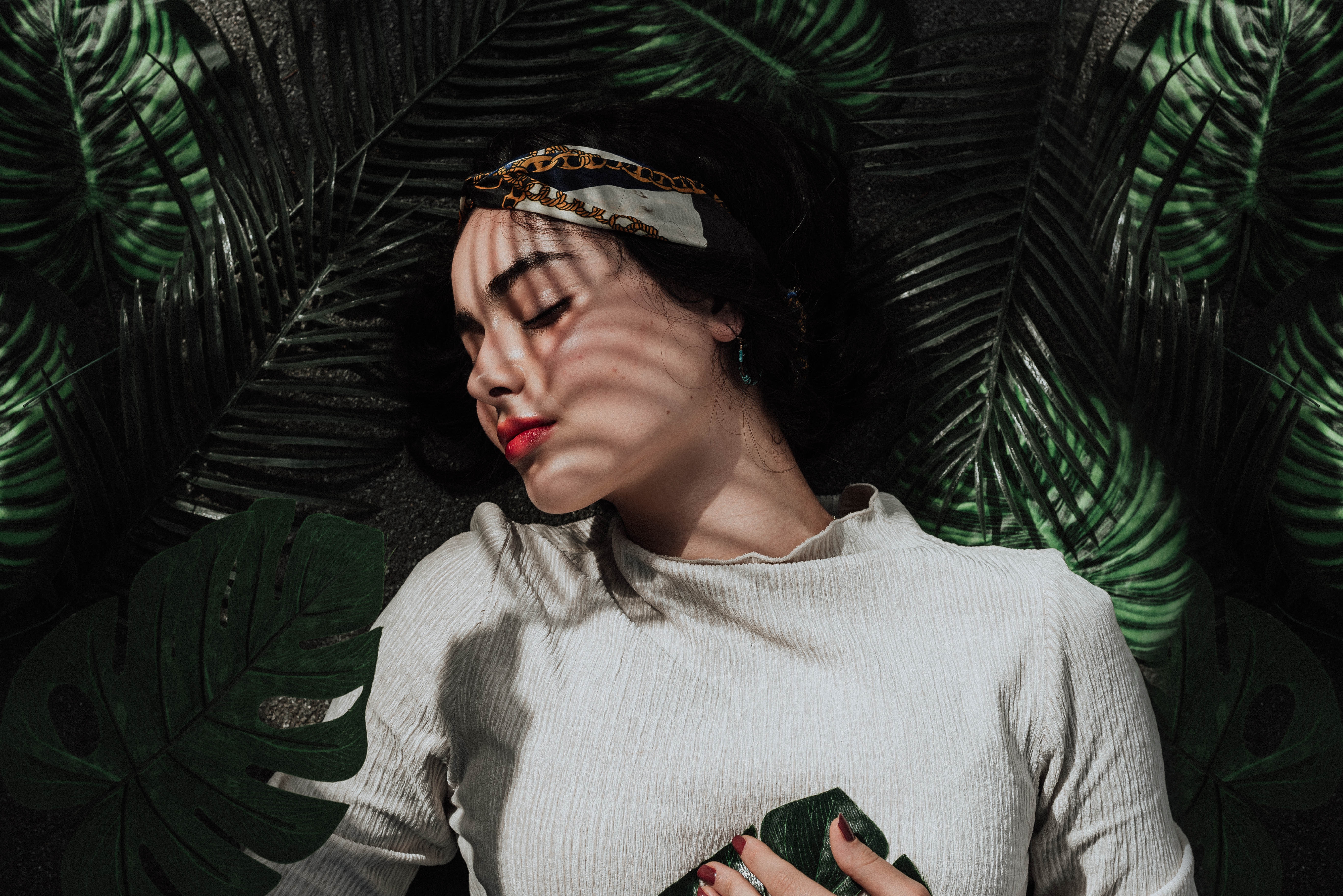 Woman laying down with shadows and foliage HD Wallpaper