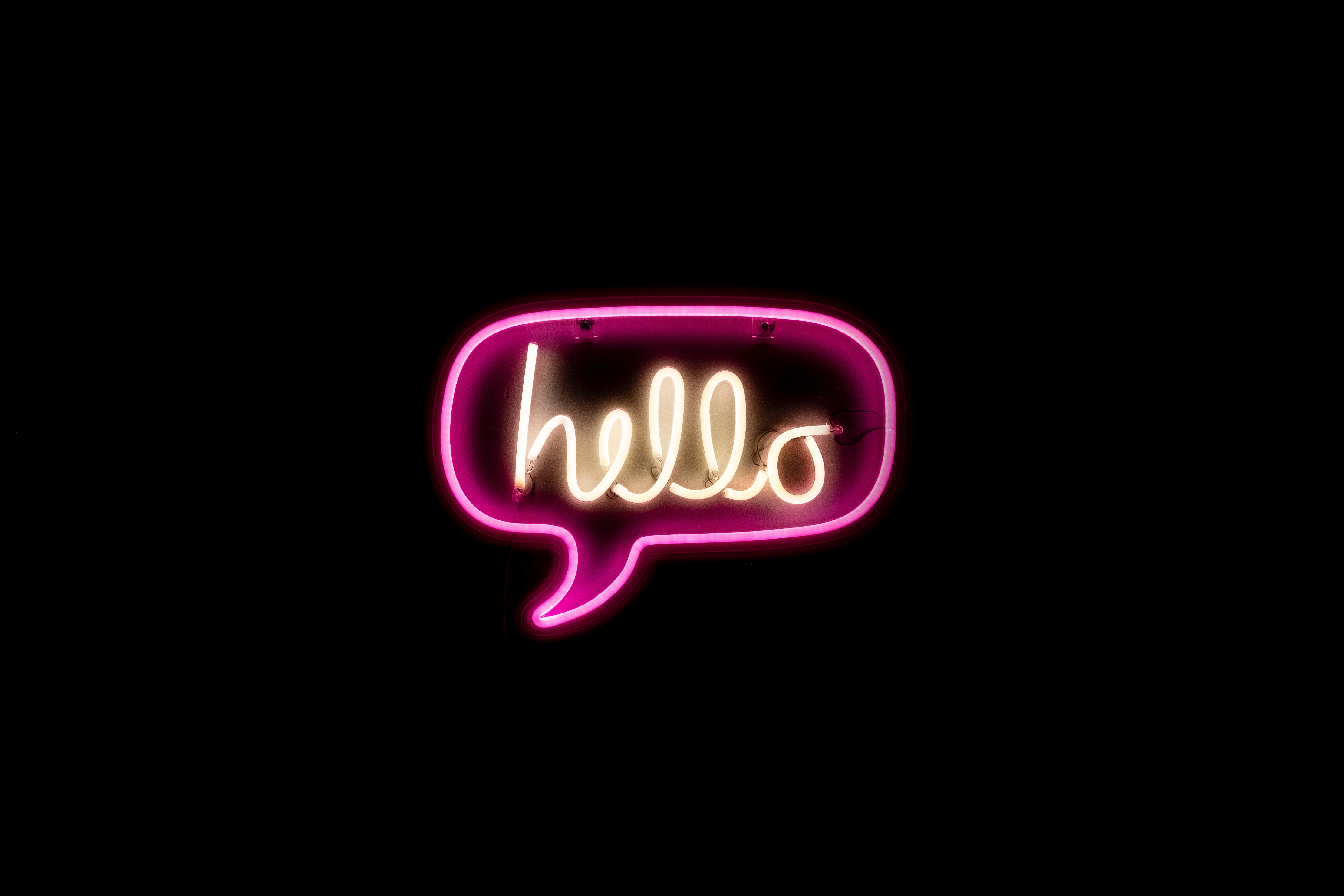 Pink neon "hello" sign in a speech bubble HD Wallpaper