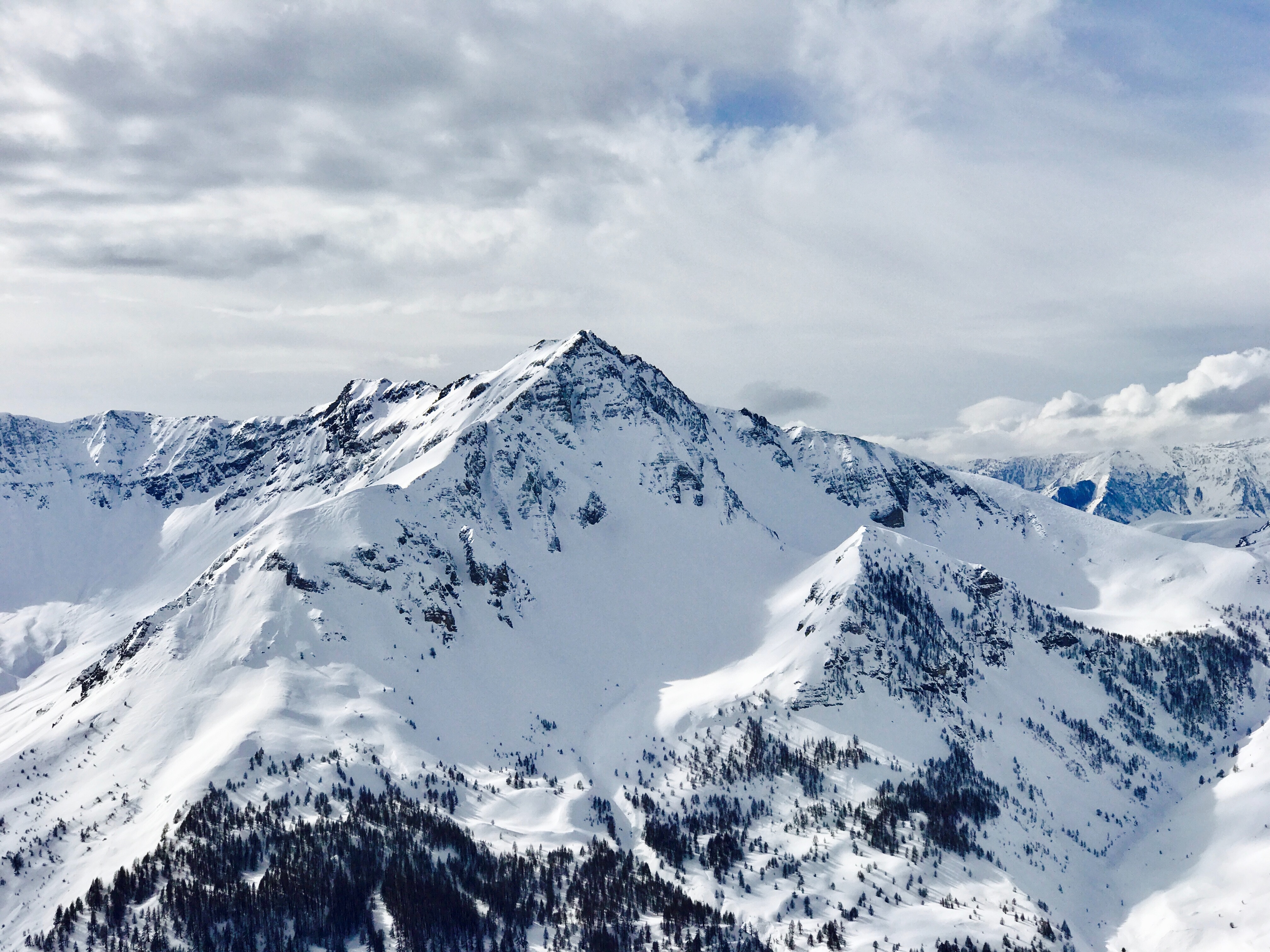 Snowy mountain range with cloudy sky in France HD Wallpaper