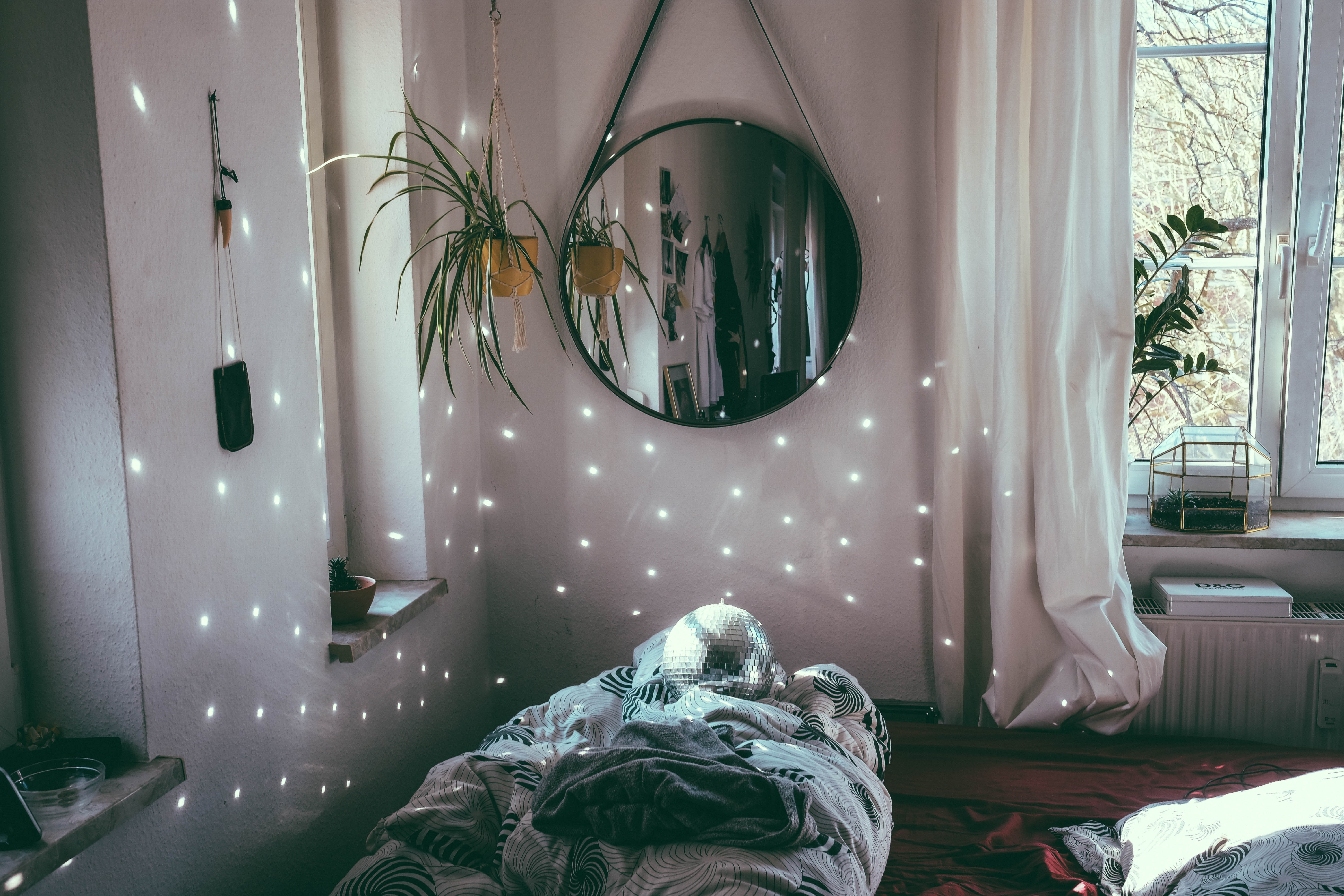 Bedroom with hanging plants, mirror, and disco ball HD Wallpaper