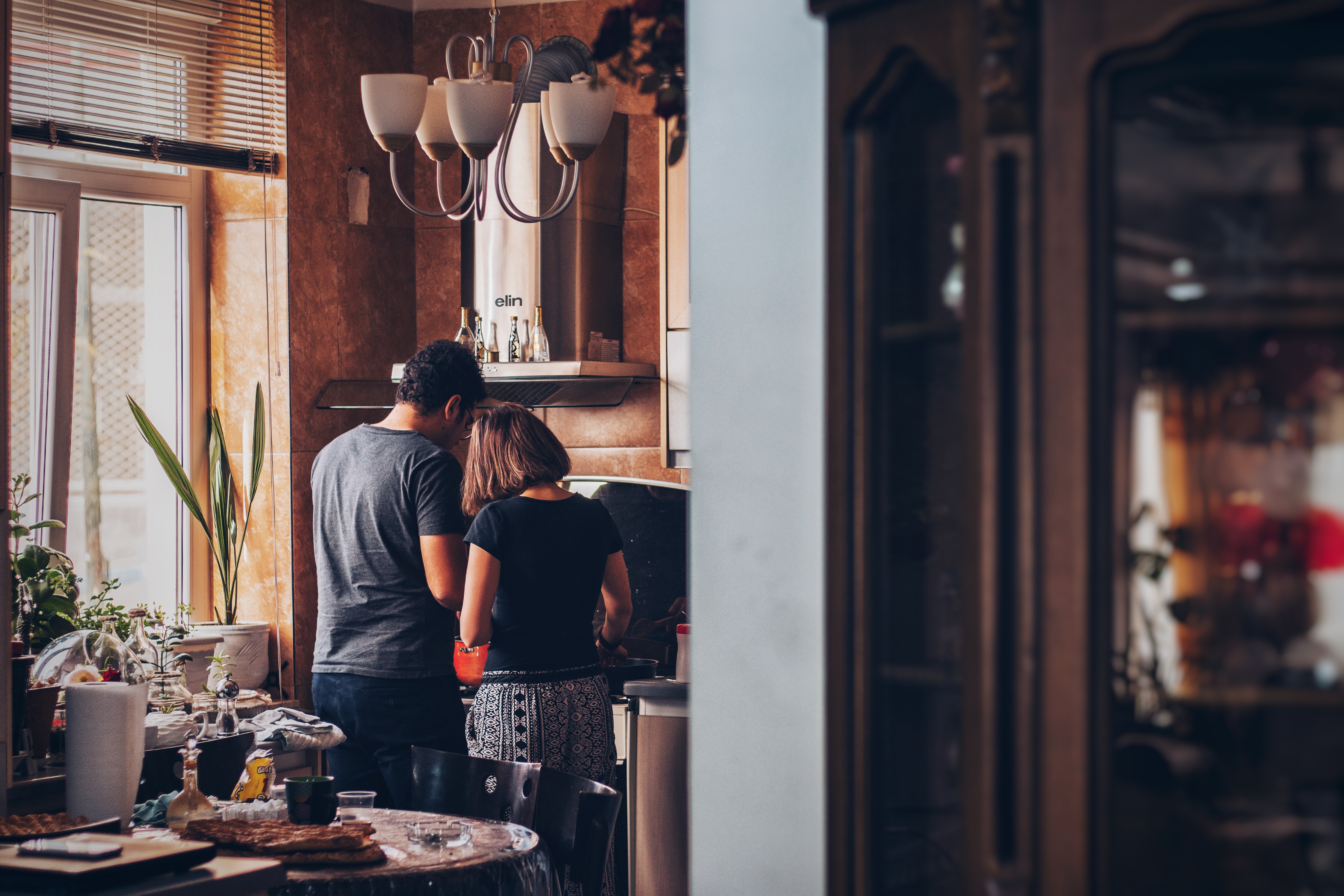 Couple cooking breakfast in a kitchen HD Wallpaper
