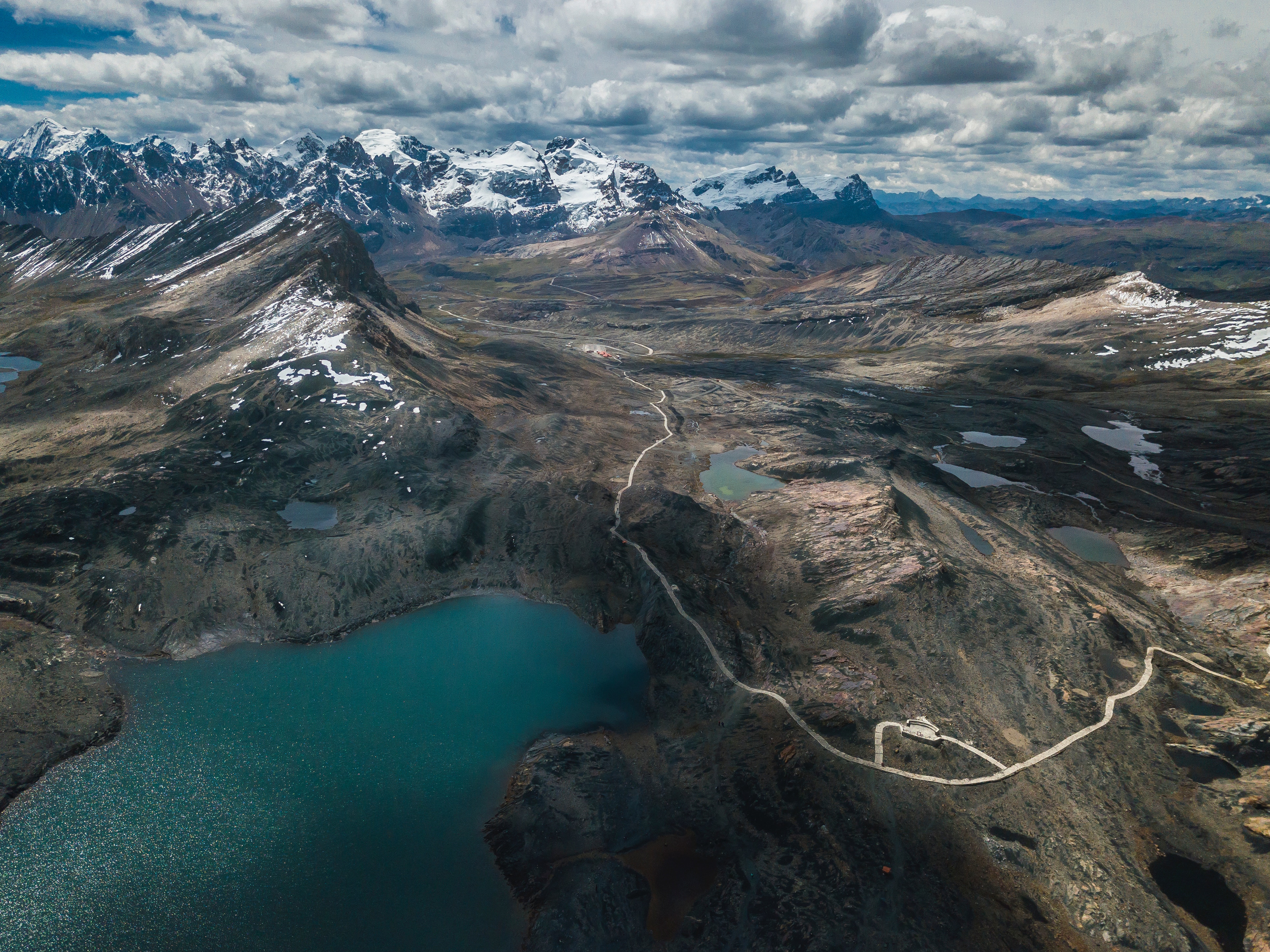 Aerial view of snowcapped mountains and lakes in Peru HD Wallpaper