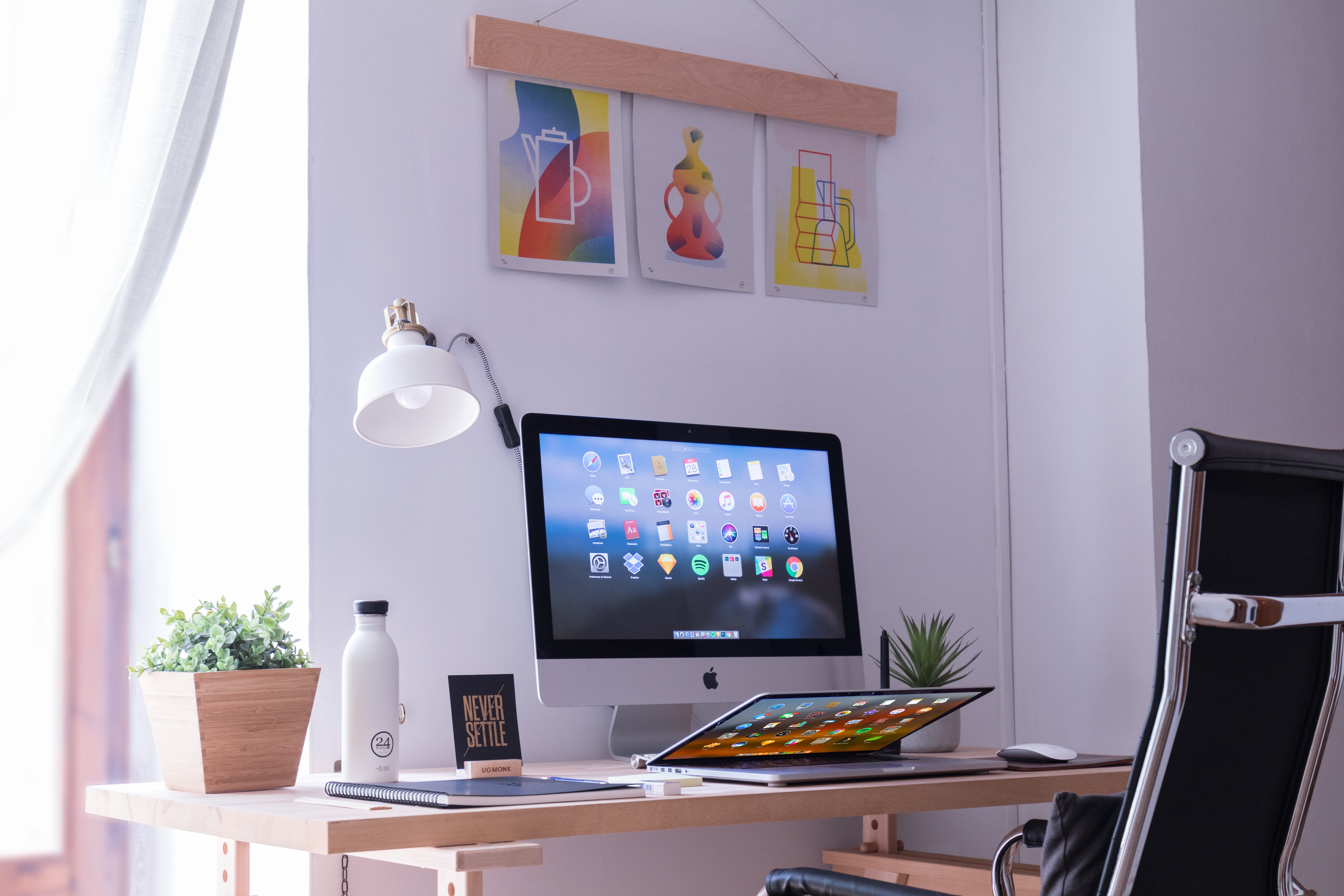 Minimalist Workspace with iMac, Laptop, and Desk Plant HD Wallpaper