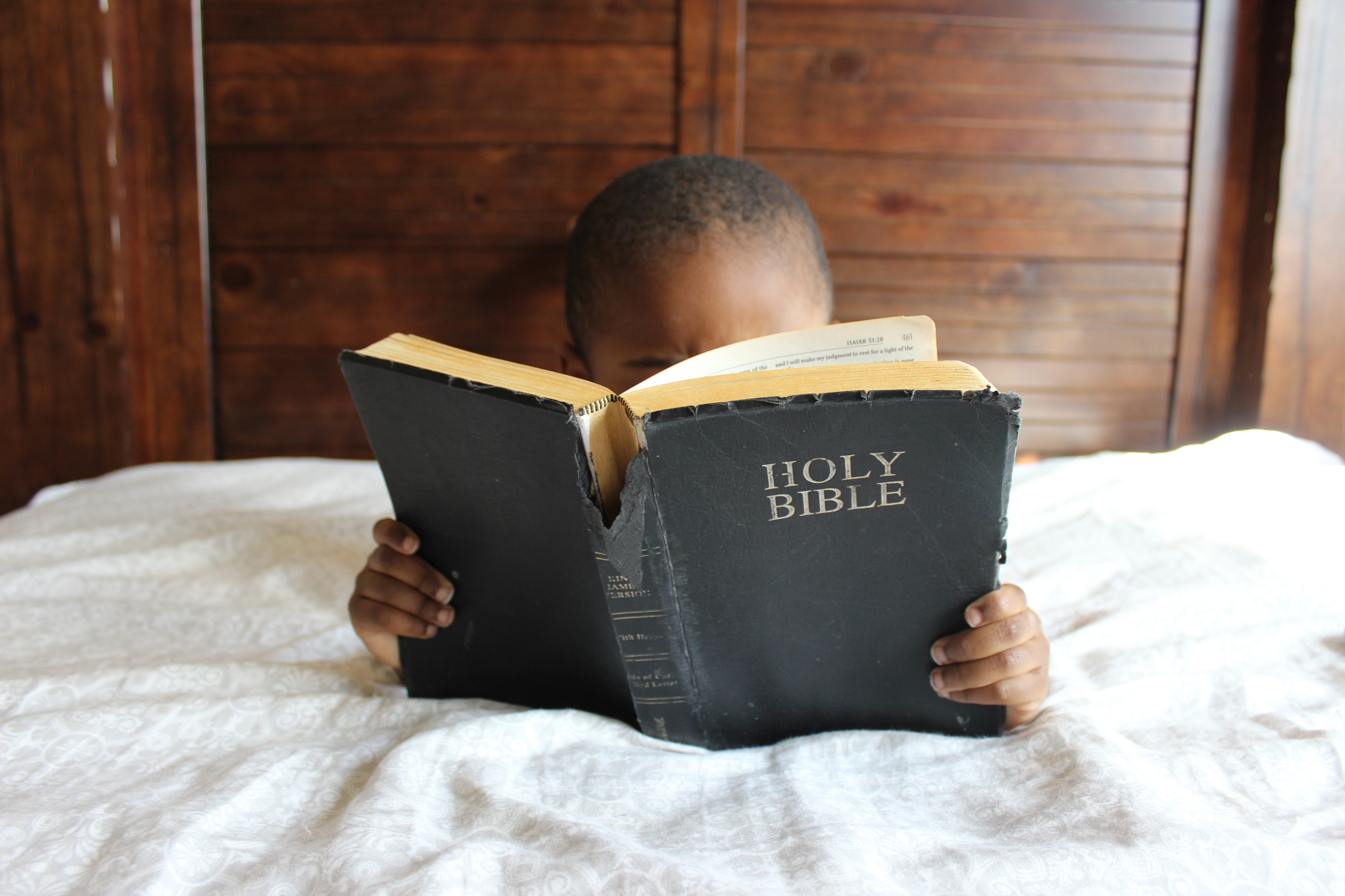 Child Reading the Holy Bible in Bed HD Wallpaper
