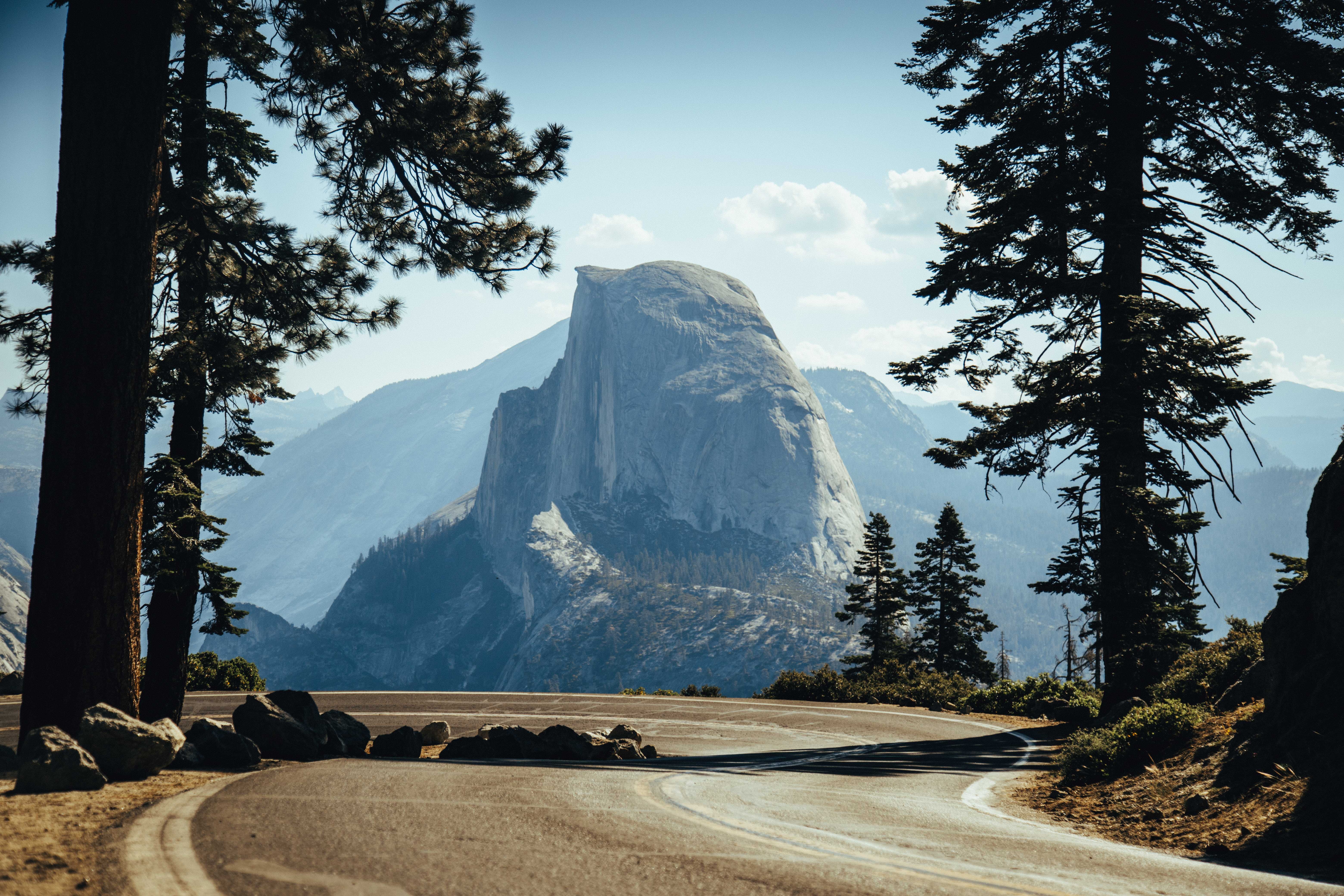 Half Dome in Yosemite National Park with a winding road HD Wallpaper