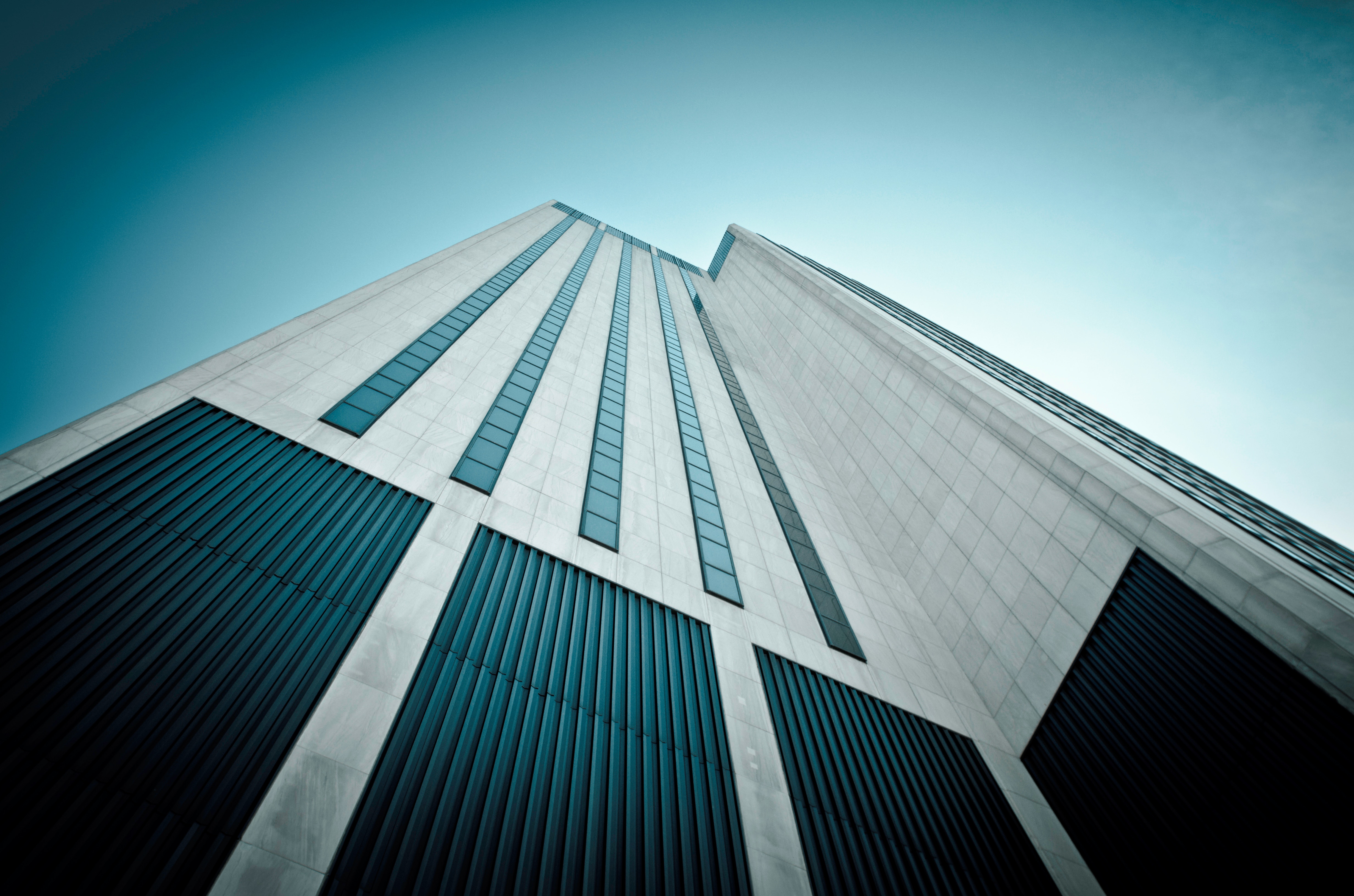 Modern Skyscraper with Blue Windows and Clear Sky HD Wallpaper