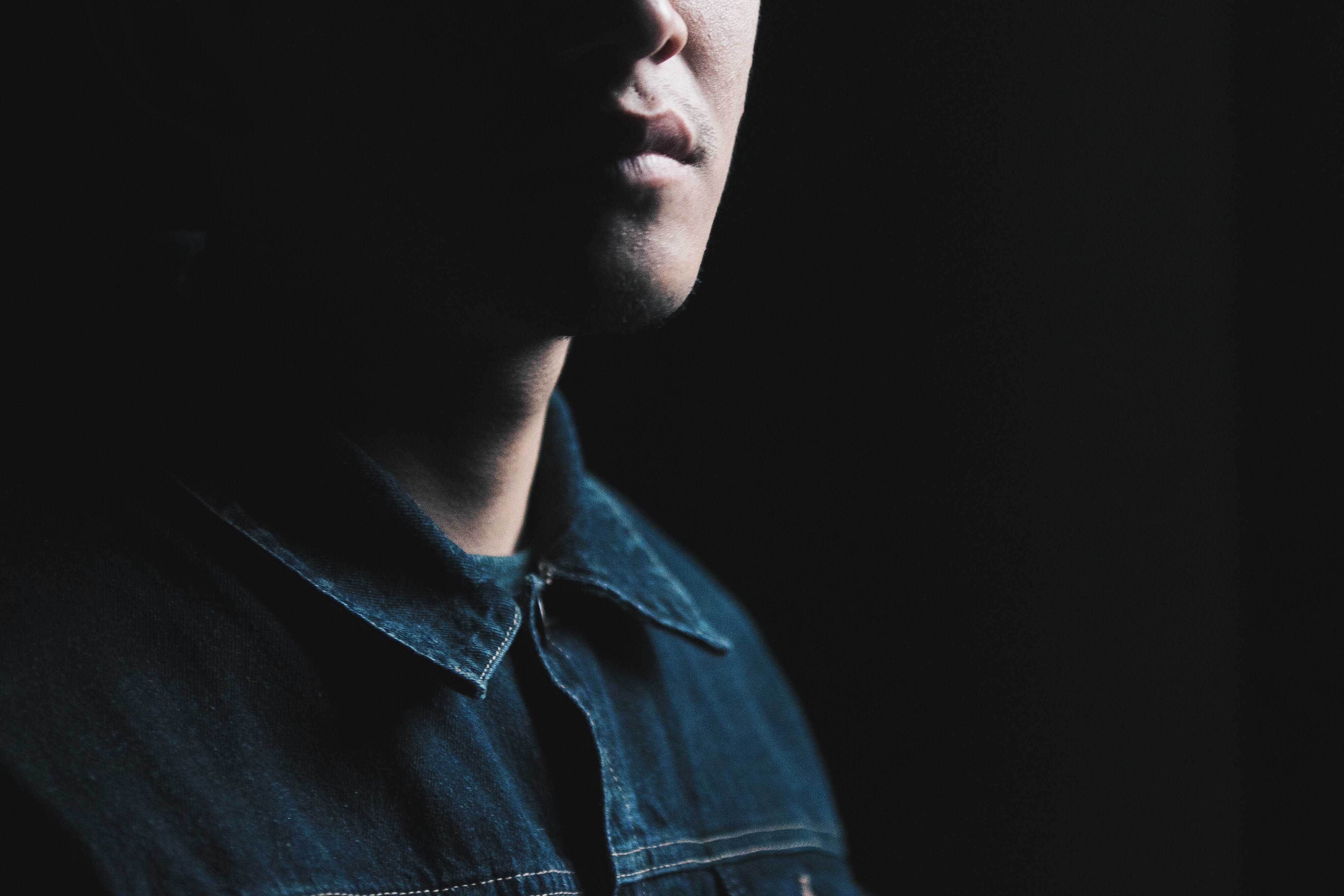 Man in denim shirt with dramatic lighting HD Wallpaper