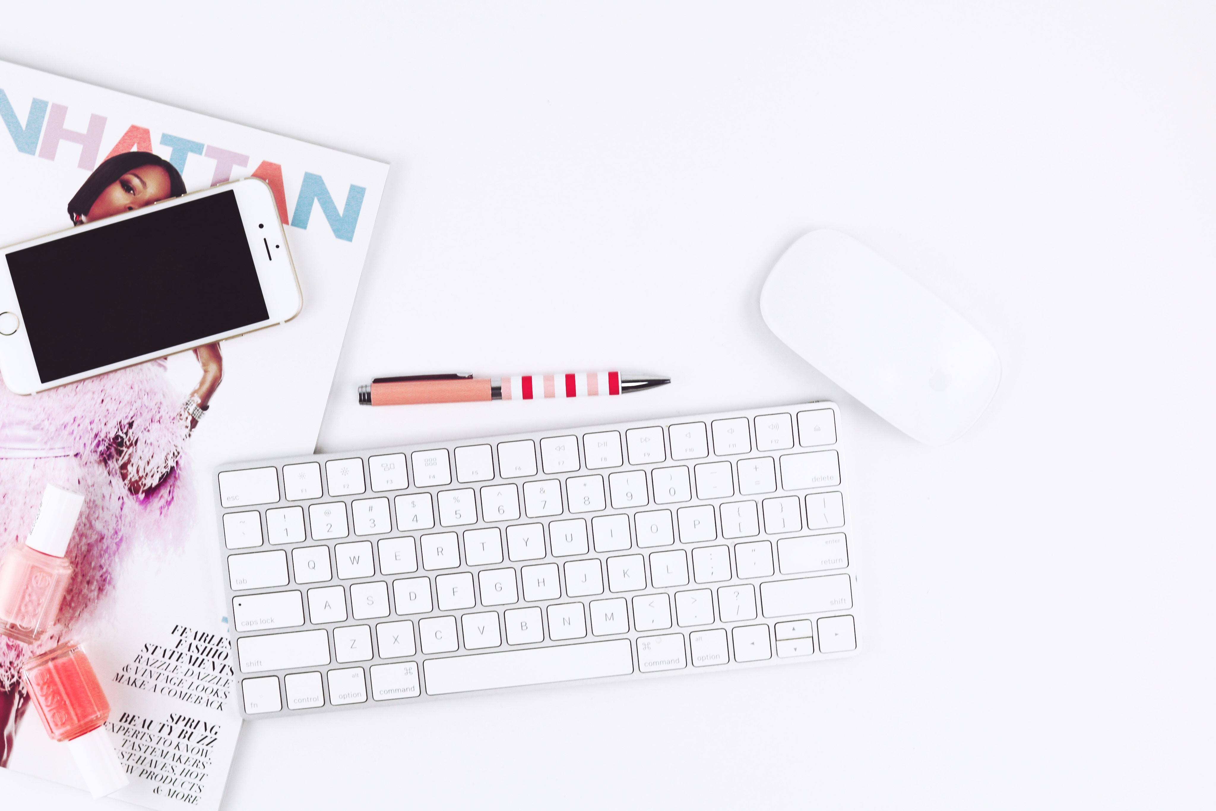 Flat lay of Apple keyboard, mouse, phone, and nail polish HD Wallpaper