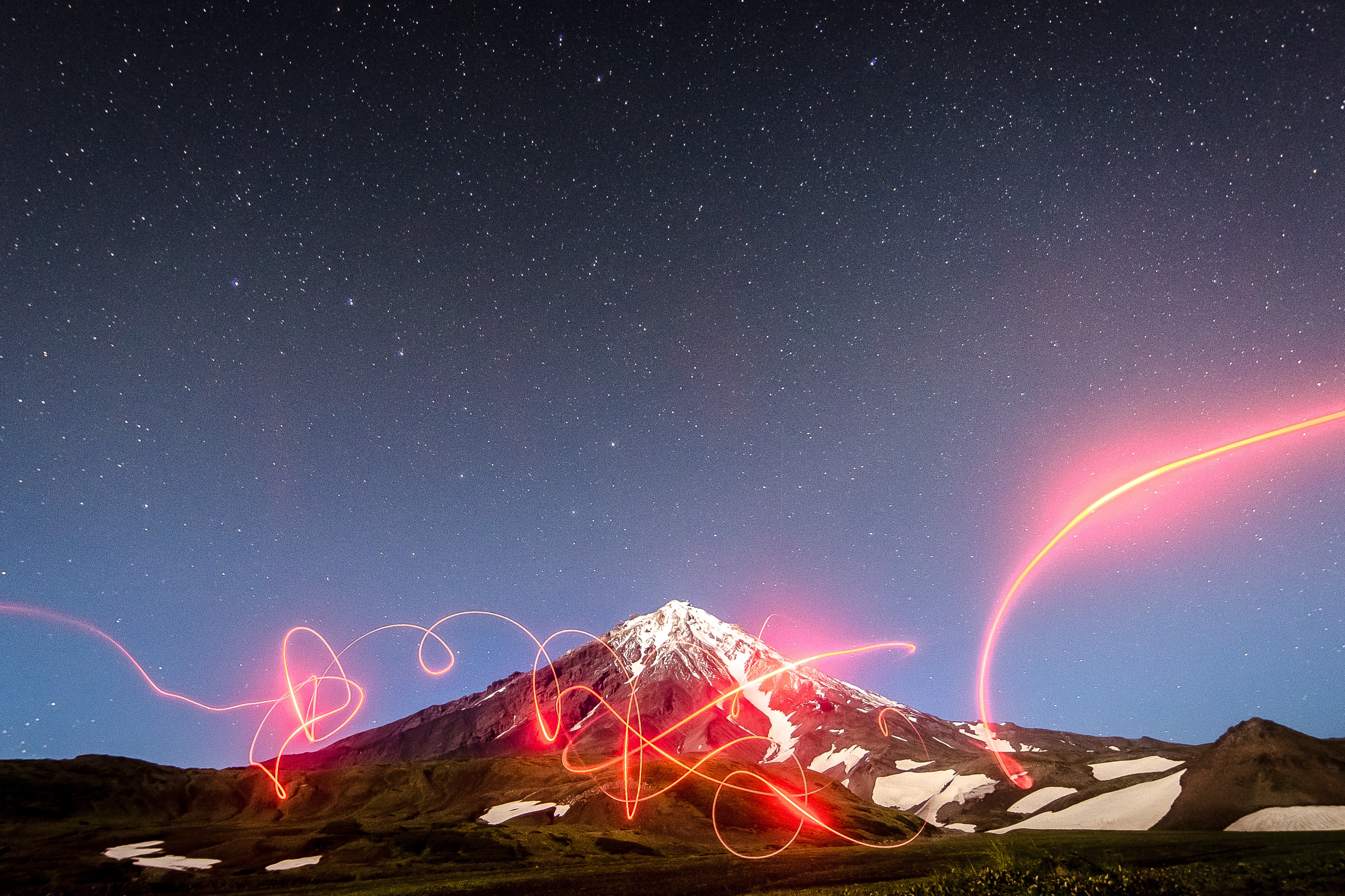 Kamchatka volcano under starry sky with light painting HD Wallpaper