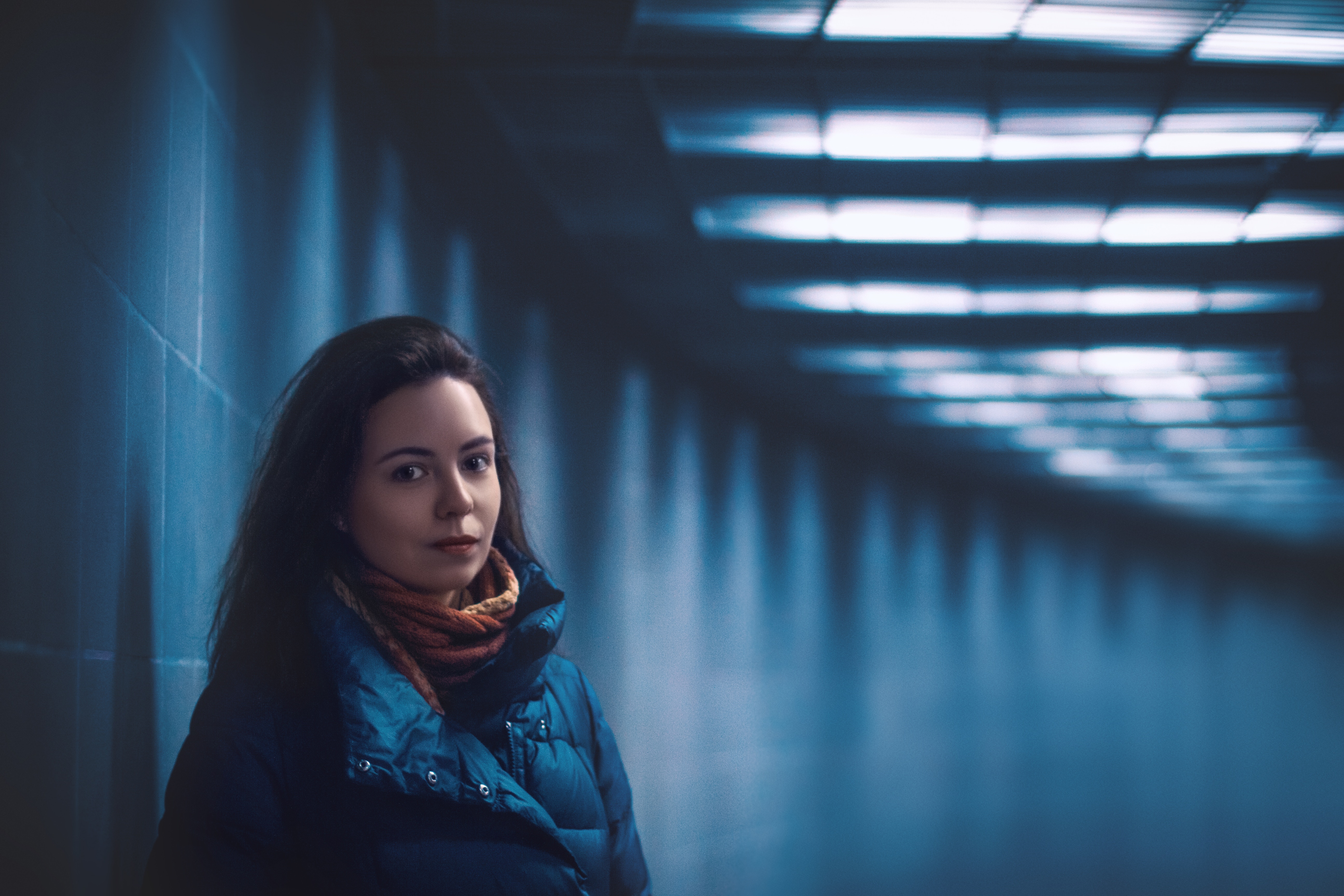 Woman in a tunnel with blue lighting HD Wallpaper