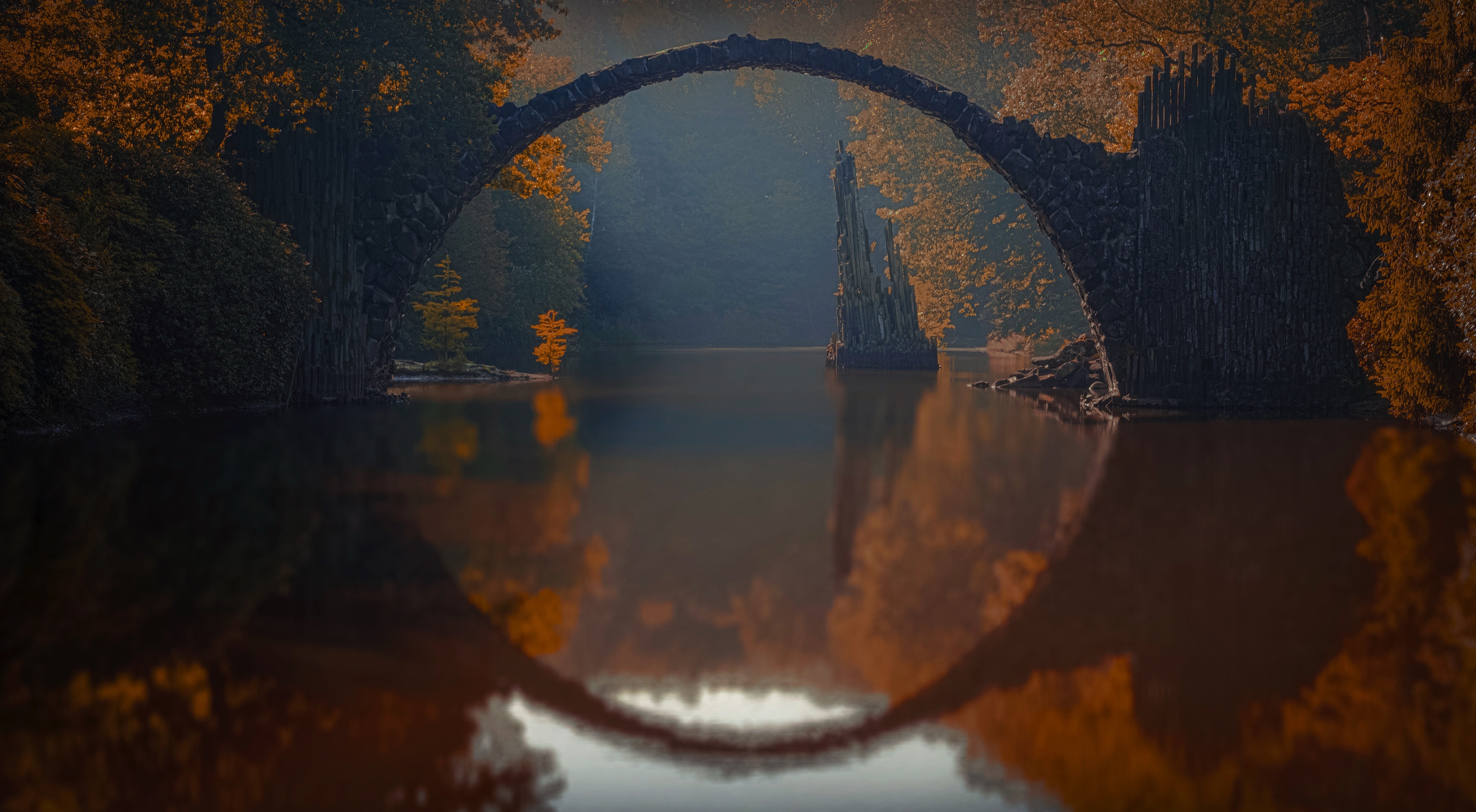Rakotzbrücke bridge reflection in water during autumn HD Wallpaper
