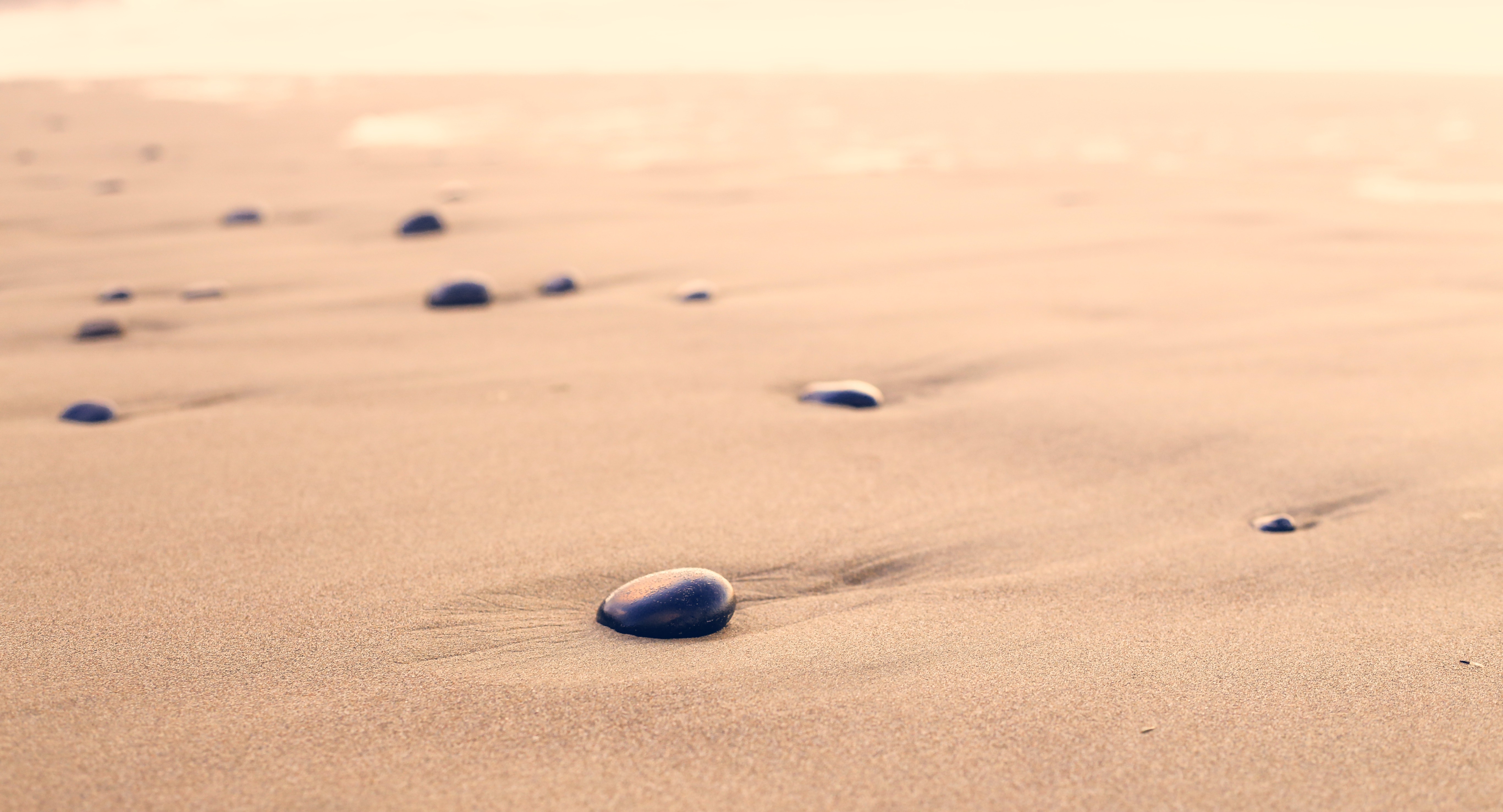 Pebbles on a Sandy Beach HD Wallpaper