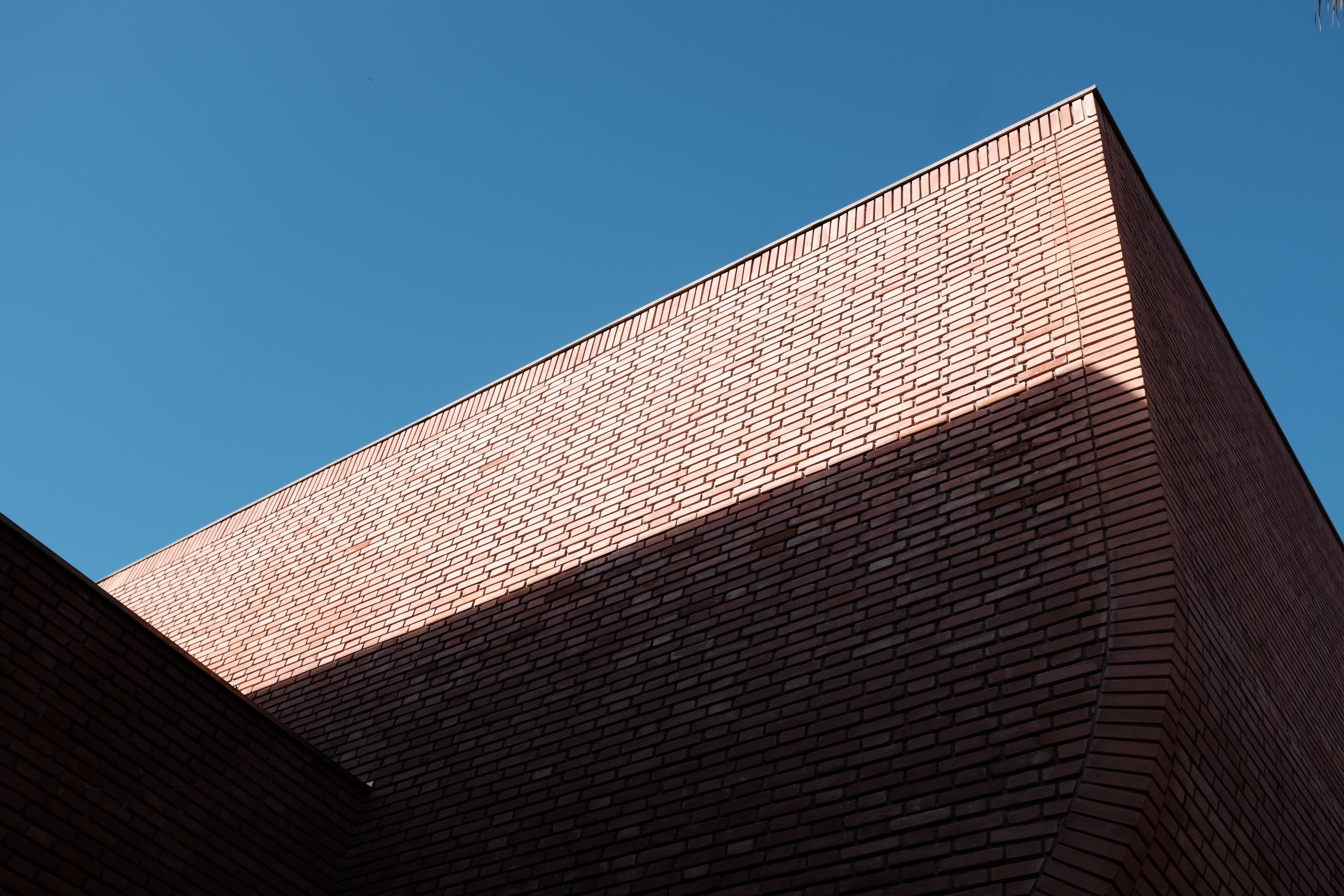 Geometric Brick Building Against Blue Sky HD Wallpaper