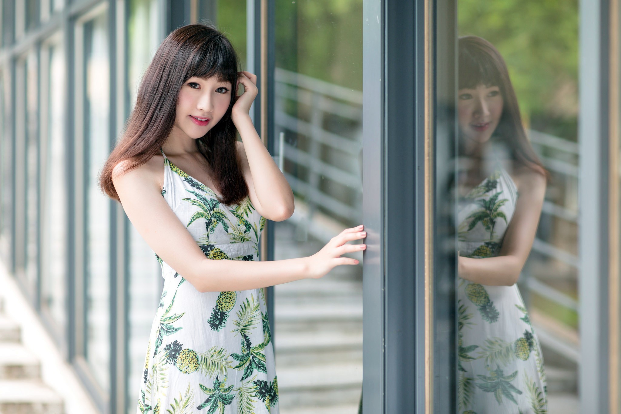 Asian woman in a tropical dress by a window HD Wallpaper