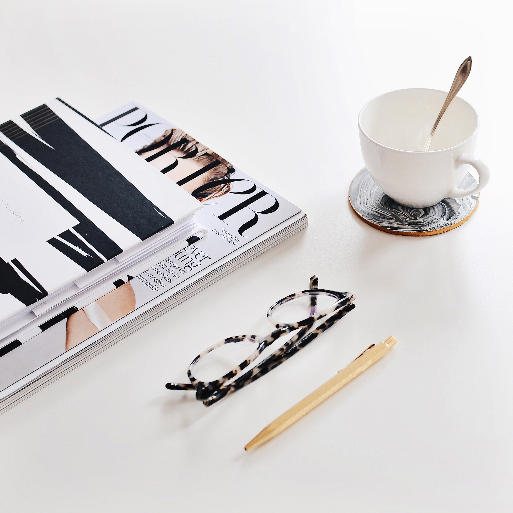 Porter magazine, glasses, and coffee cup on a white table HD Wallpaper