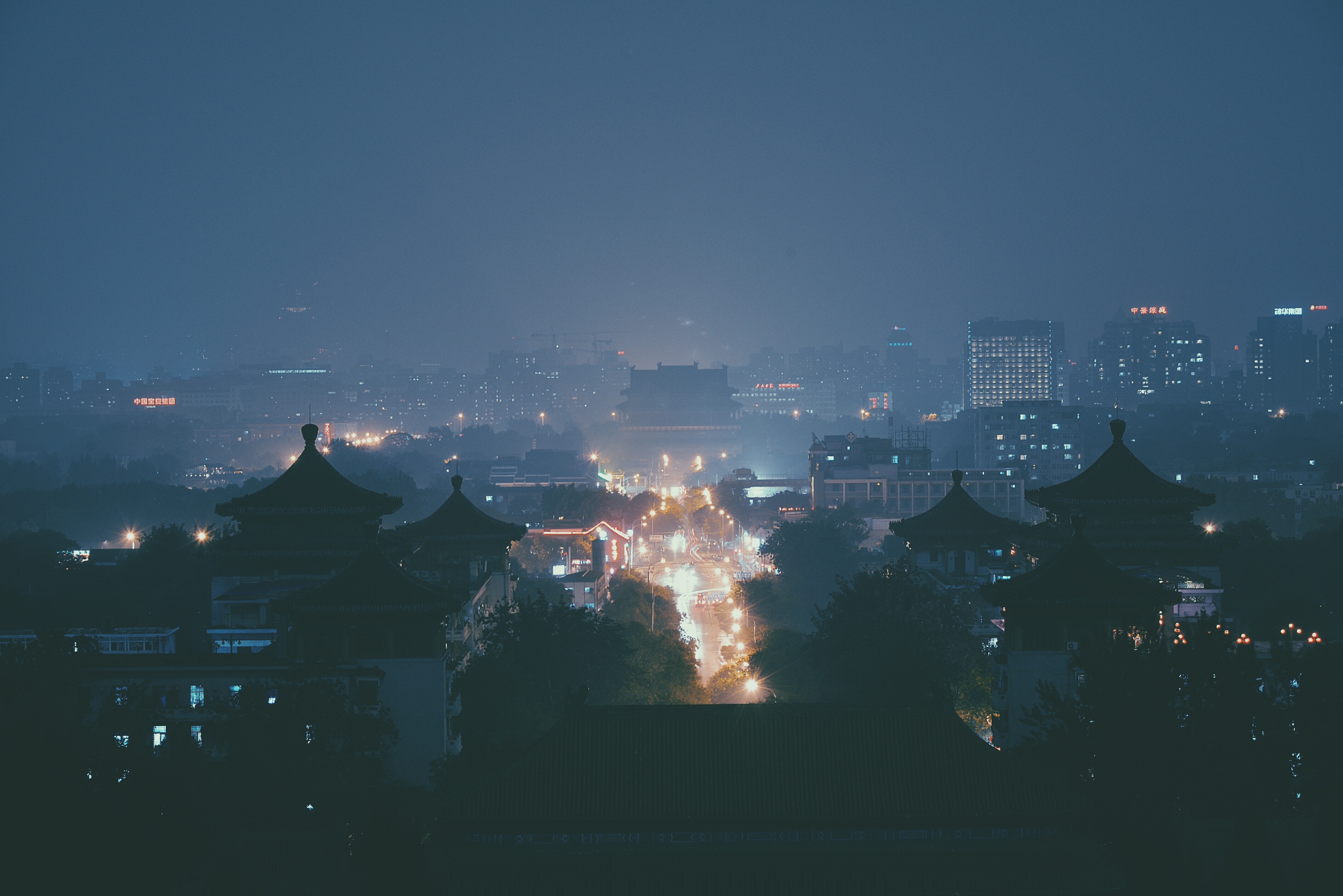City skyline at night with traditional Asian architecture HD Wallpaper