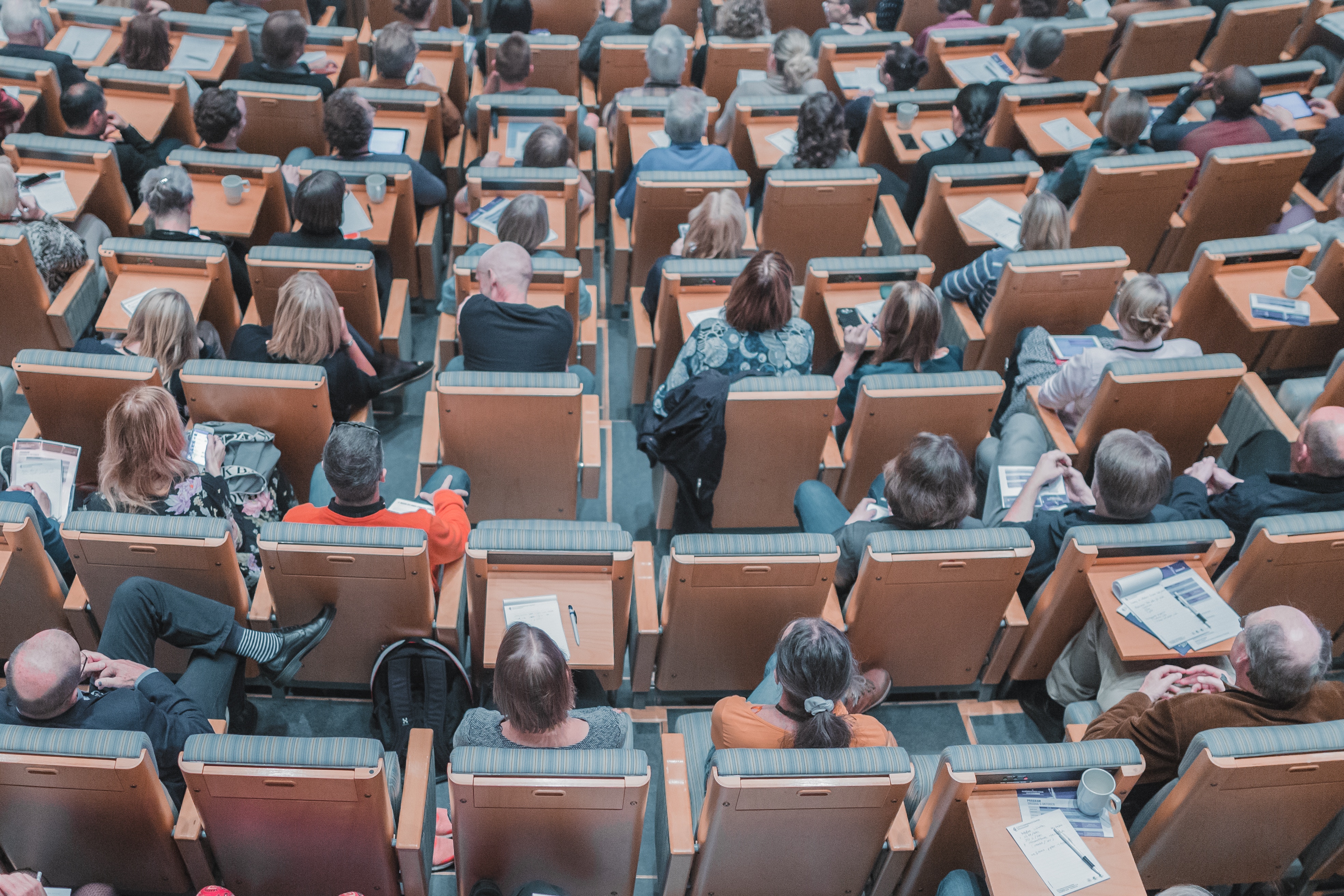 Audience seated in a university lecture hall HD Wallpaper