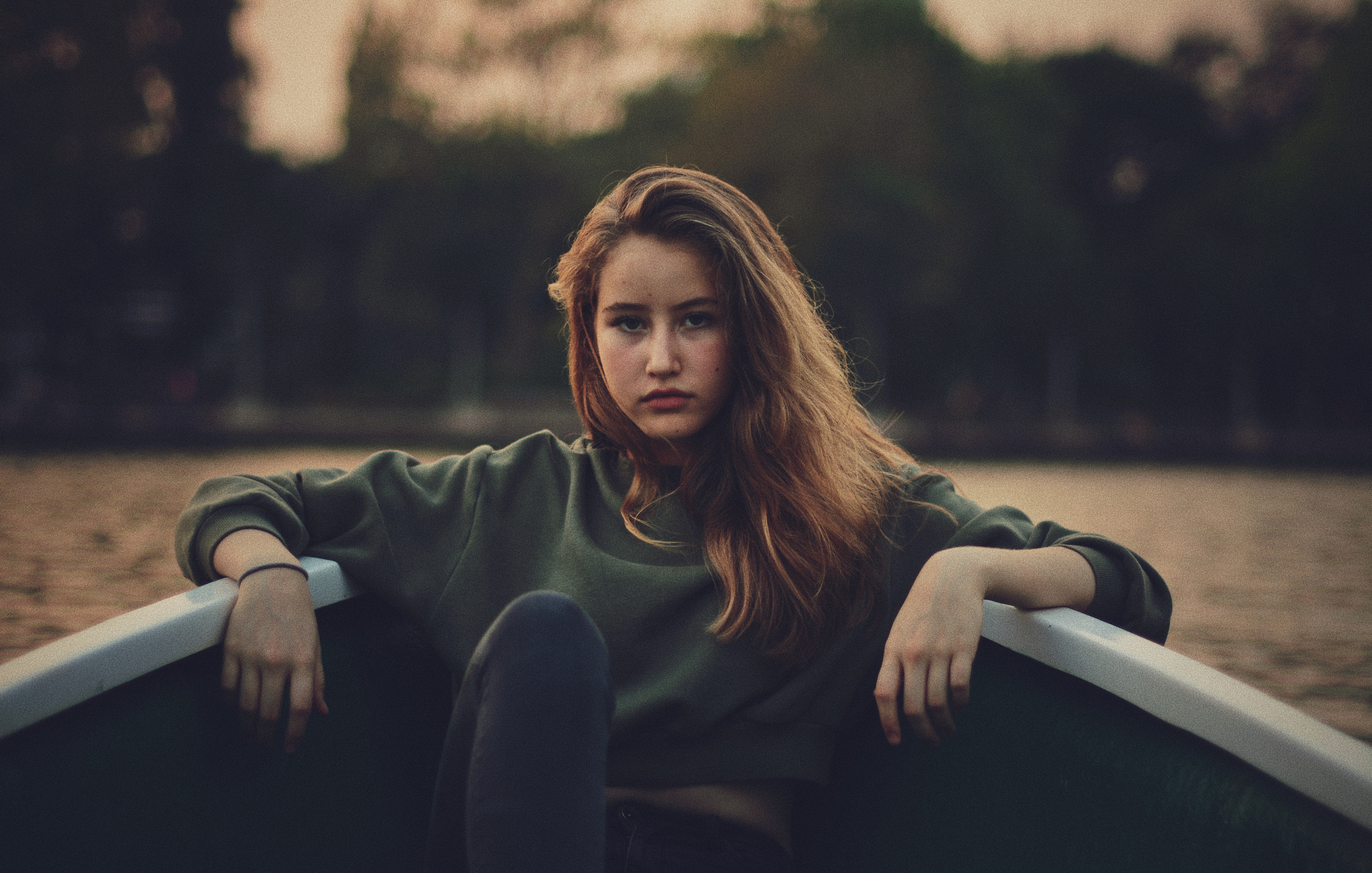 Girl sitting in a boat at dusk HD Wallpaper