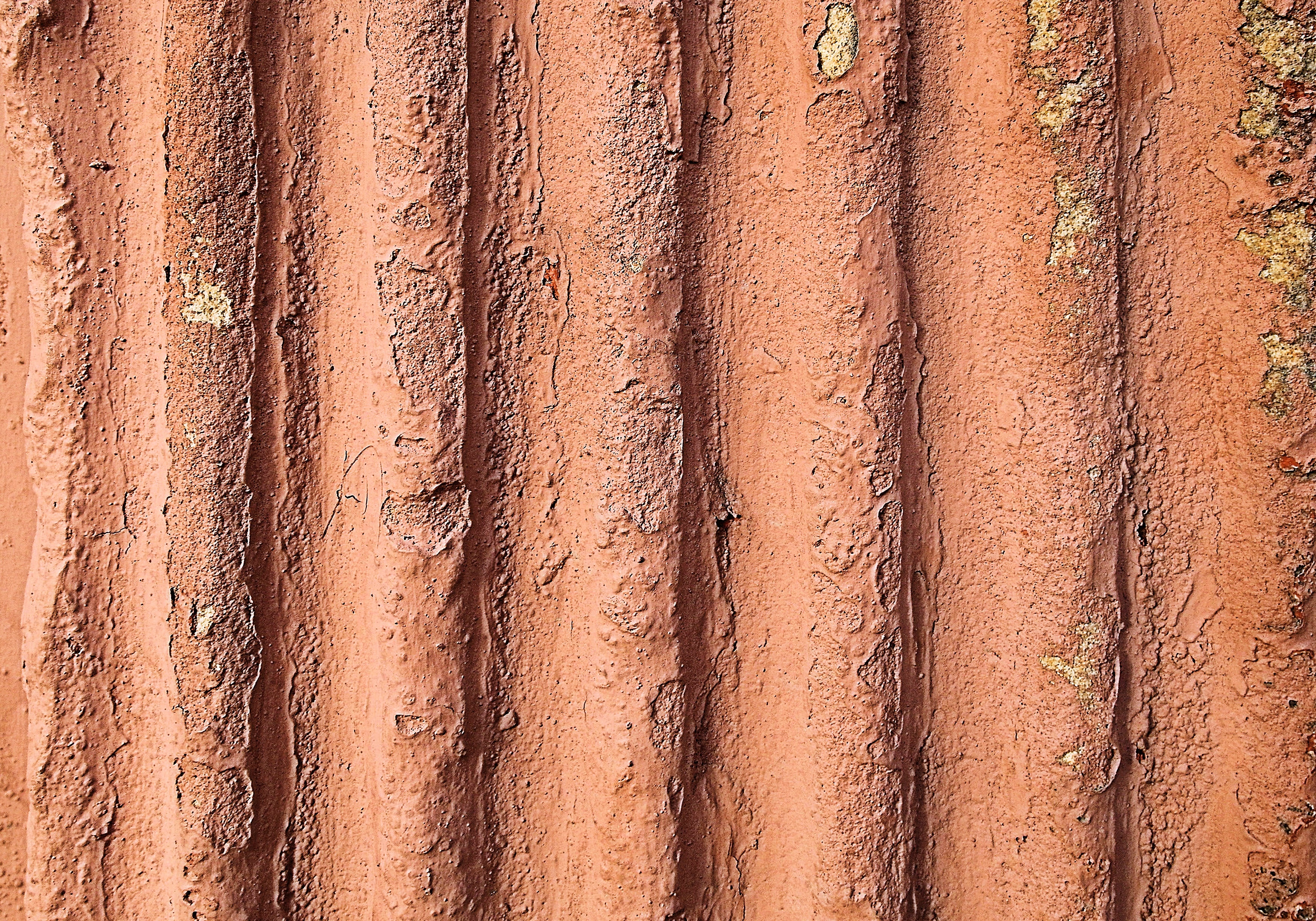 Close-up of a weathered, corrugated surface with peeling paint HD Wallpaper