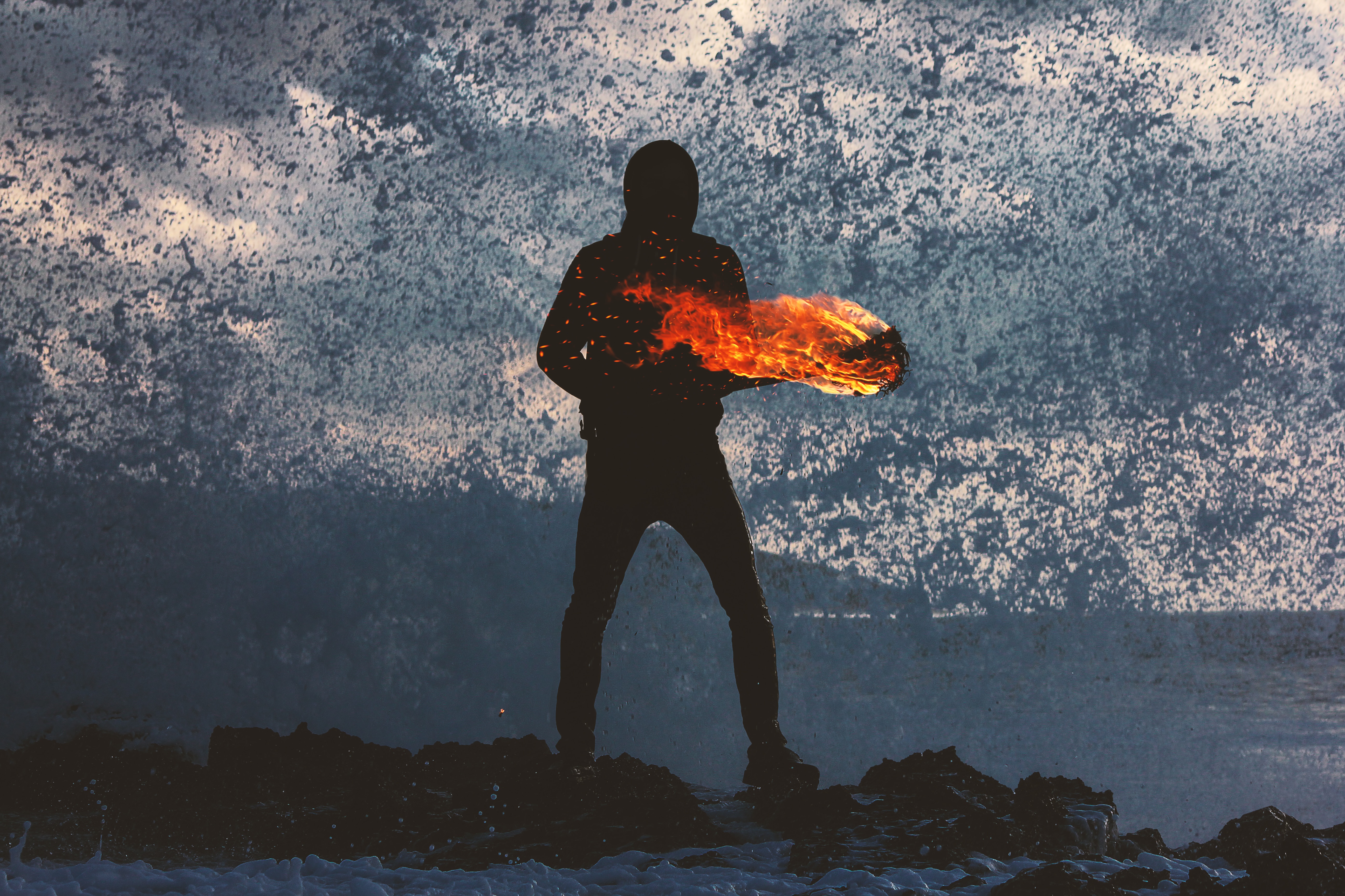 Silhouette of a person holding fire against a wave HD Wallpaper