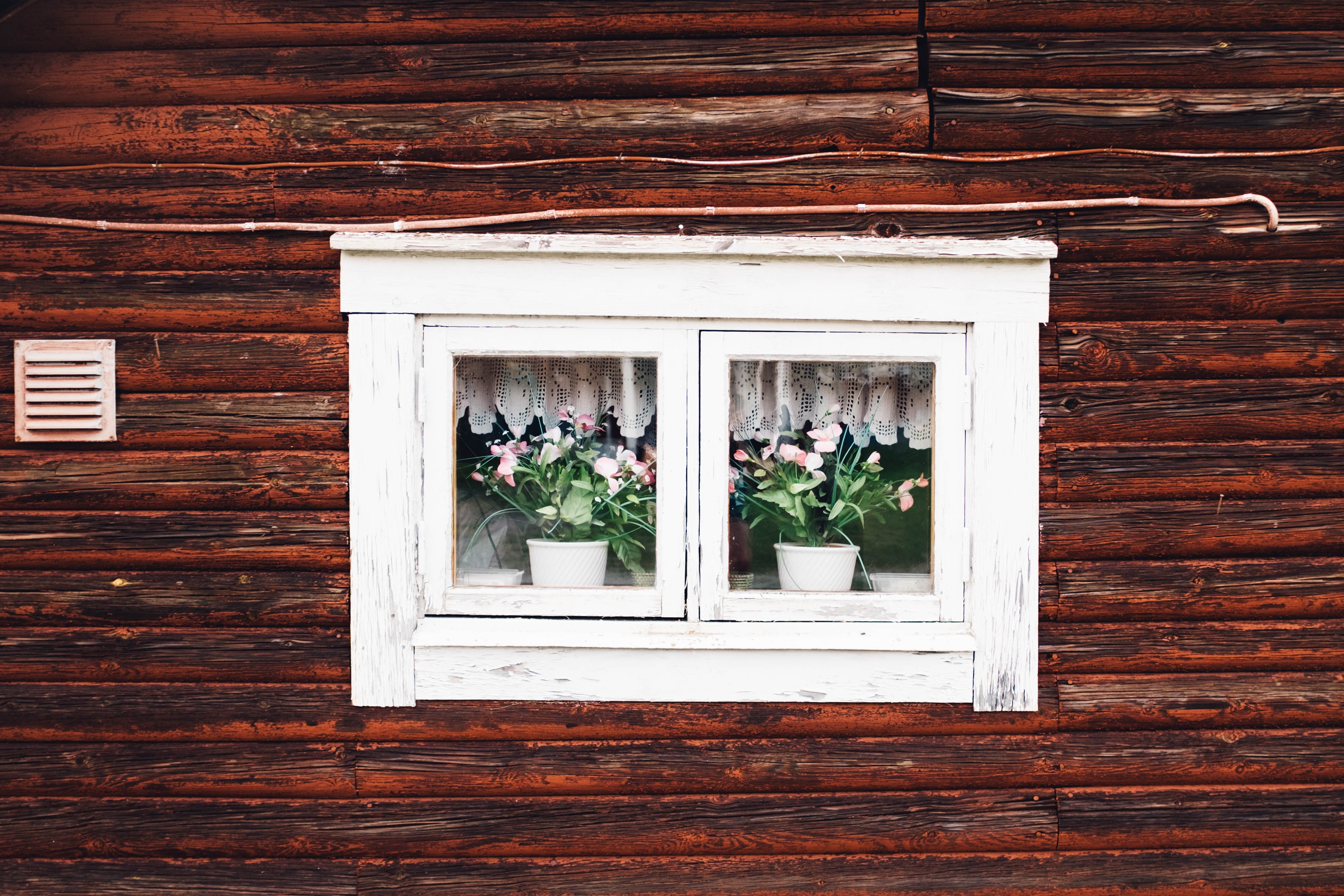 Wooden house with flowers in the window HD Wallpaper